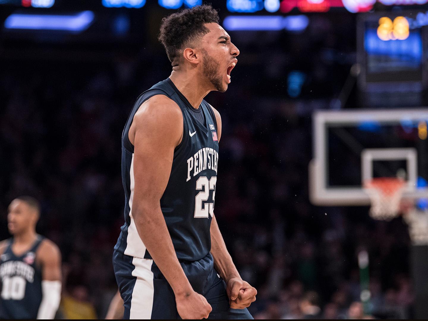 Man in basketball uniform yelling excitedly