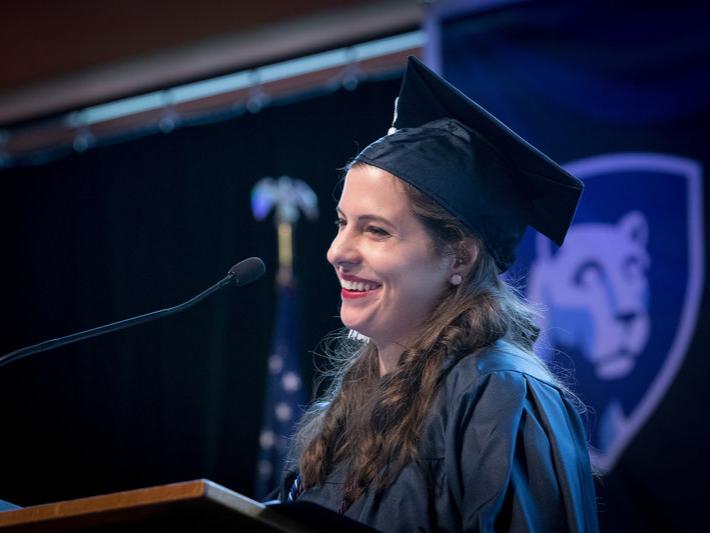woman speaking at graduation in cap and gown