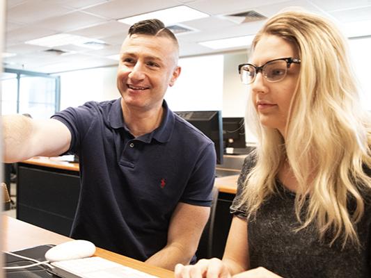 Dr. Aris Karagiorgakis, assistant teaching professor of Psychology, advises 2019 Erickson Discovery Grant recipient Kaylee Aaron. 