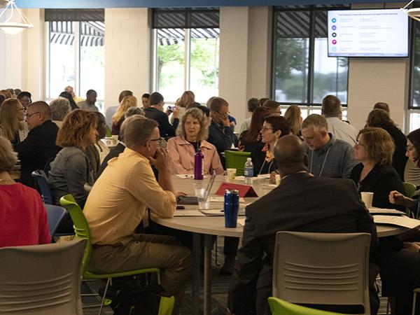 Penn State affiliates gather around tables for a pre-conference session.
