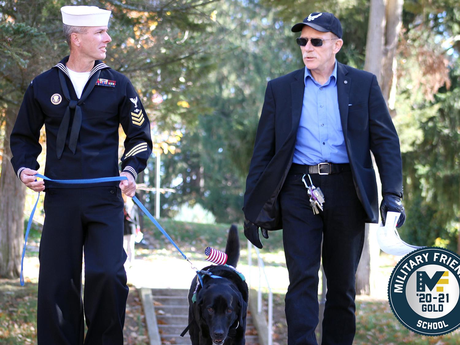 Student veteran John Wiesniewski and his service dog, Slate, cross campus with a veteran faculty member at Penn State Mont Alto.