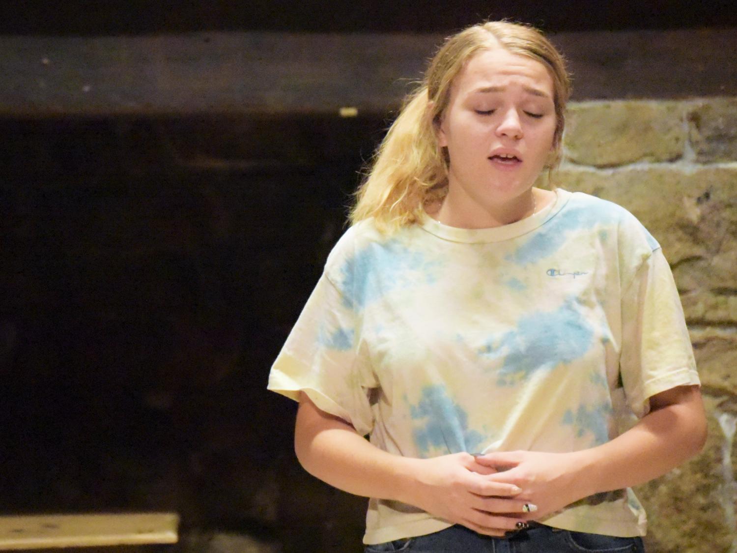 A female student sings during rehearsal for a musical theatre production at Penn State Behrend.