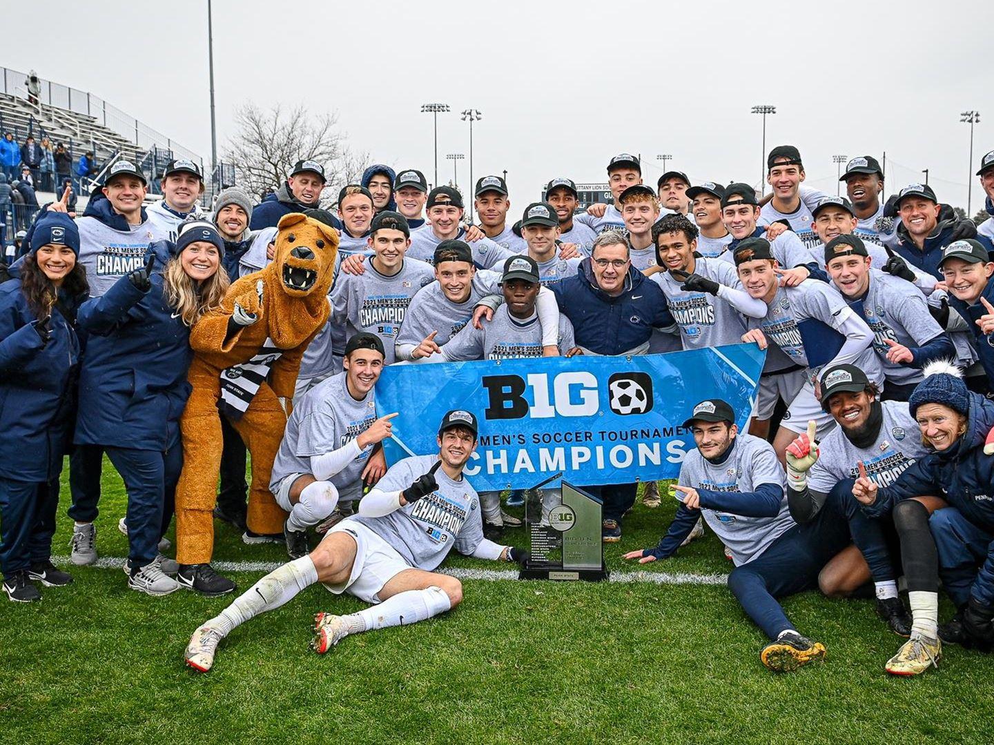 Soccer team poses with Big Ten tournament championship banner