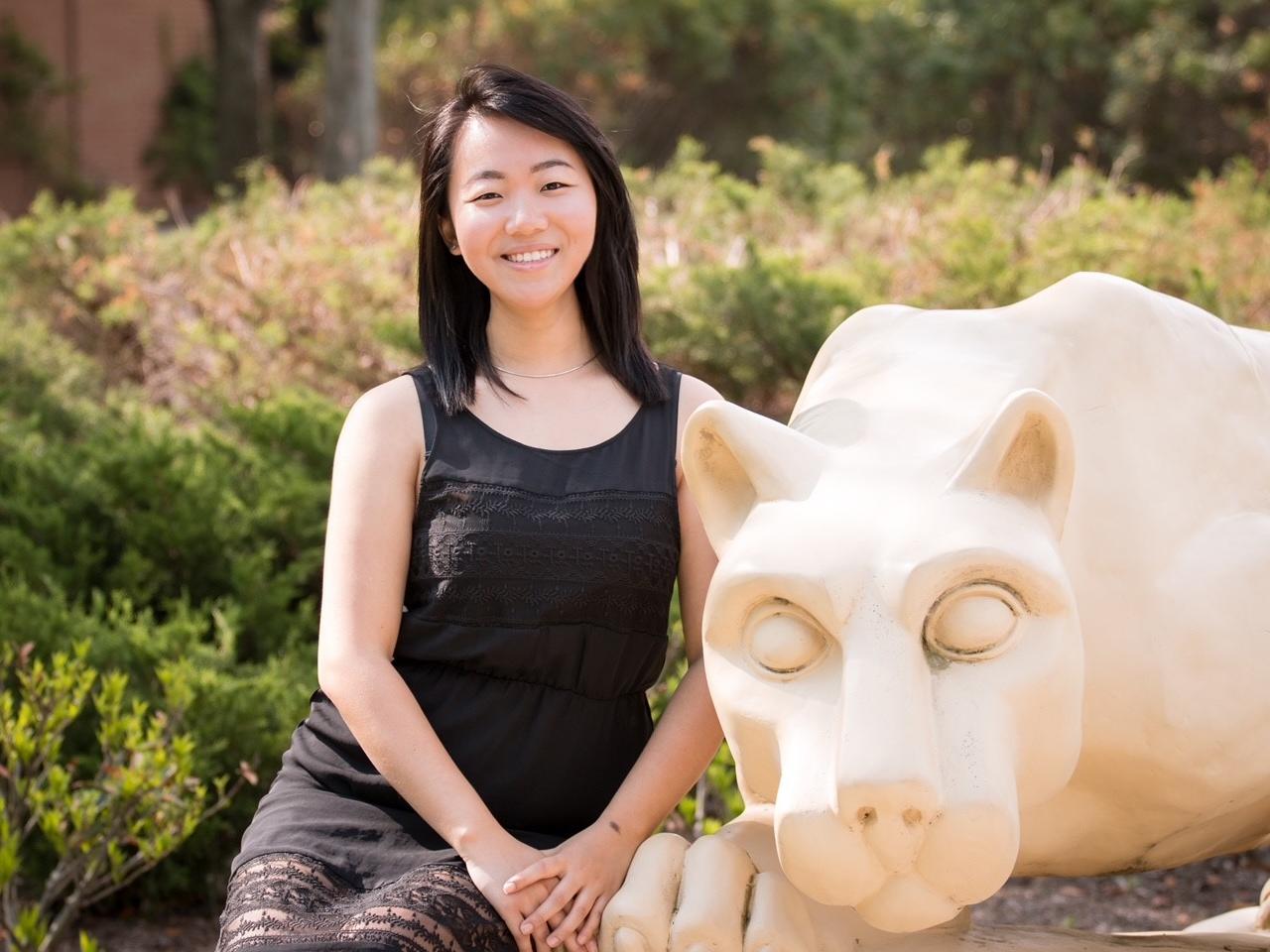 A woman posing in front of the Lion Shrine