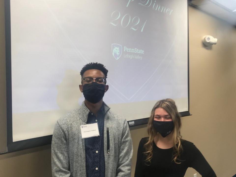 Scholarship Dinner student speakers pose against backdrop