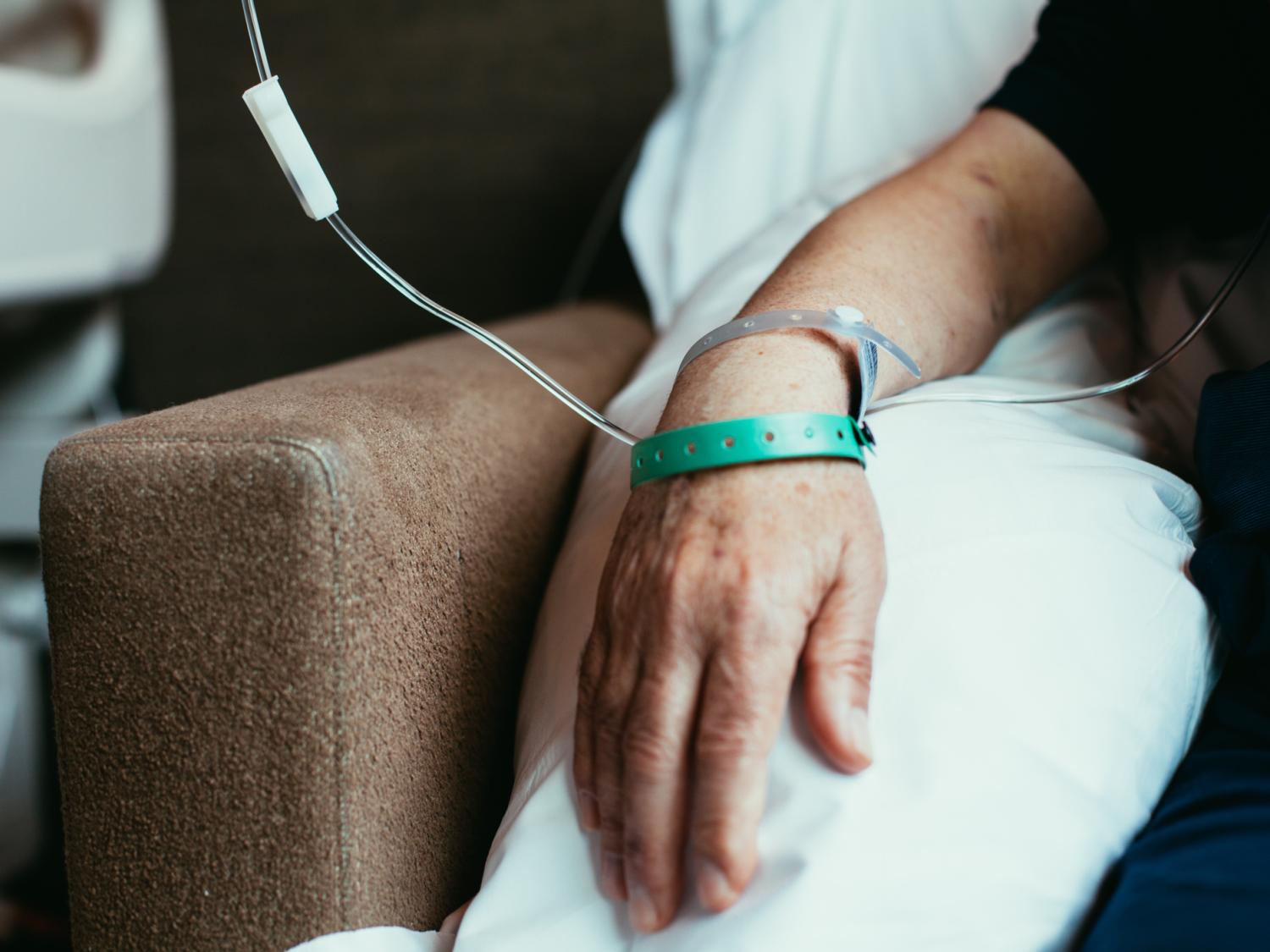 Close up of a hand connected to a machine in a hospital
