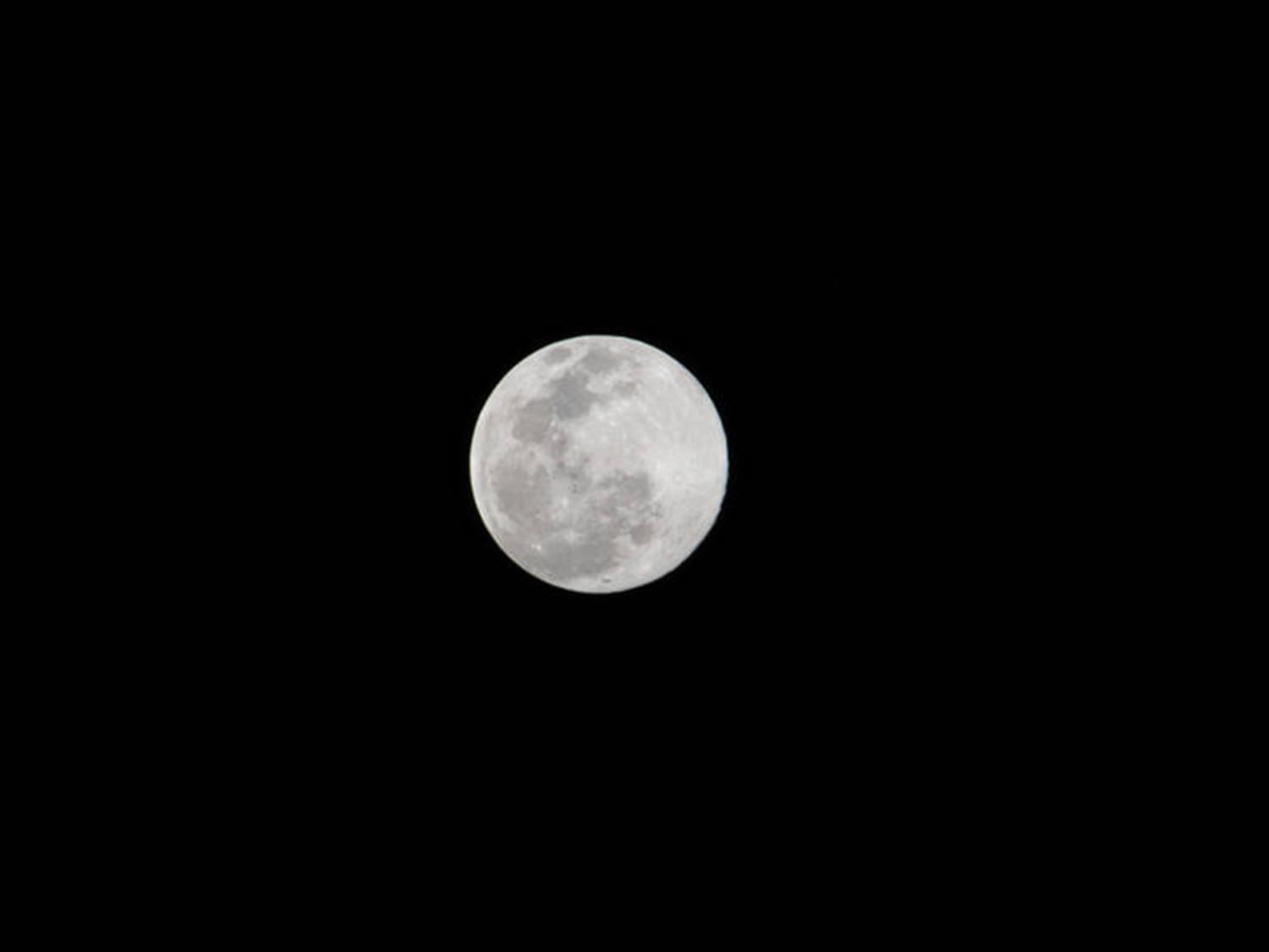 A full moon is pictured above the Earth's horizon