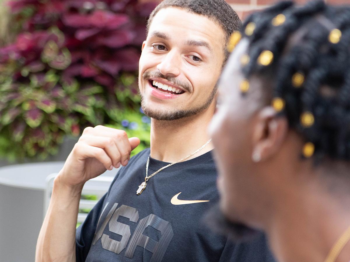 Gannon Murray talking with a friend outside. 