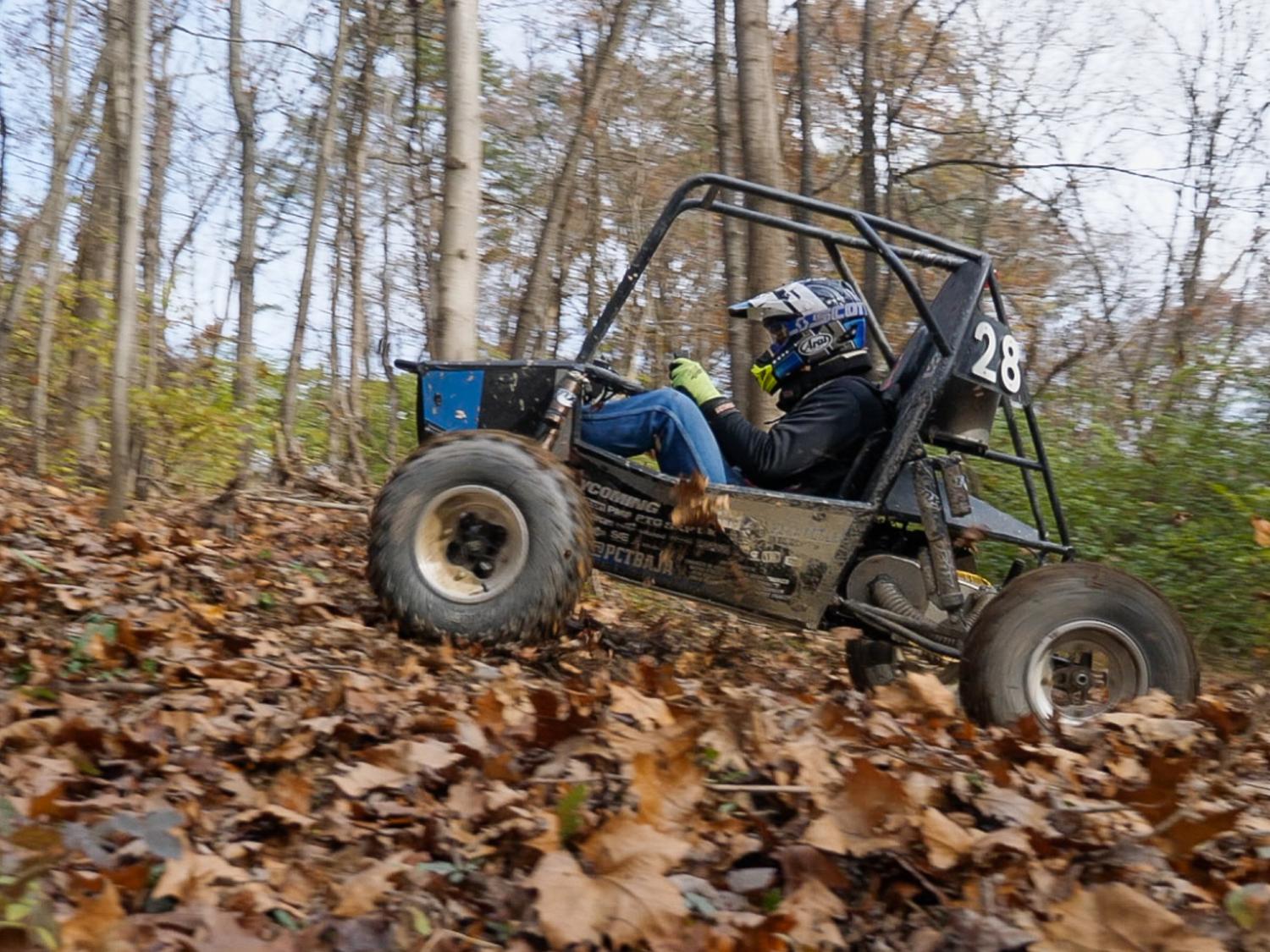 Person driving a car on a rugged test track