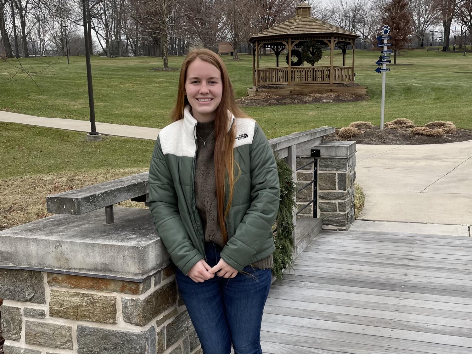 Student standing on bridge on the Penn State Brandywine campus.
