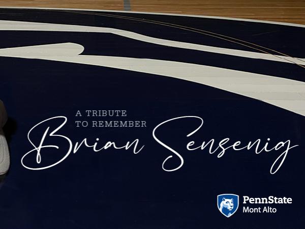 "A tribute to remember Brian Sensenig" next to a white Penn State cap