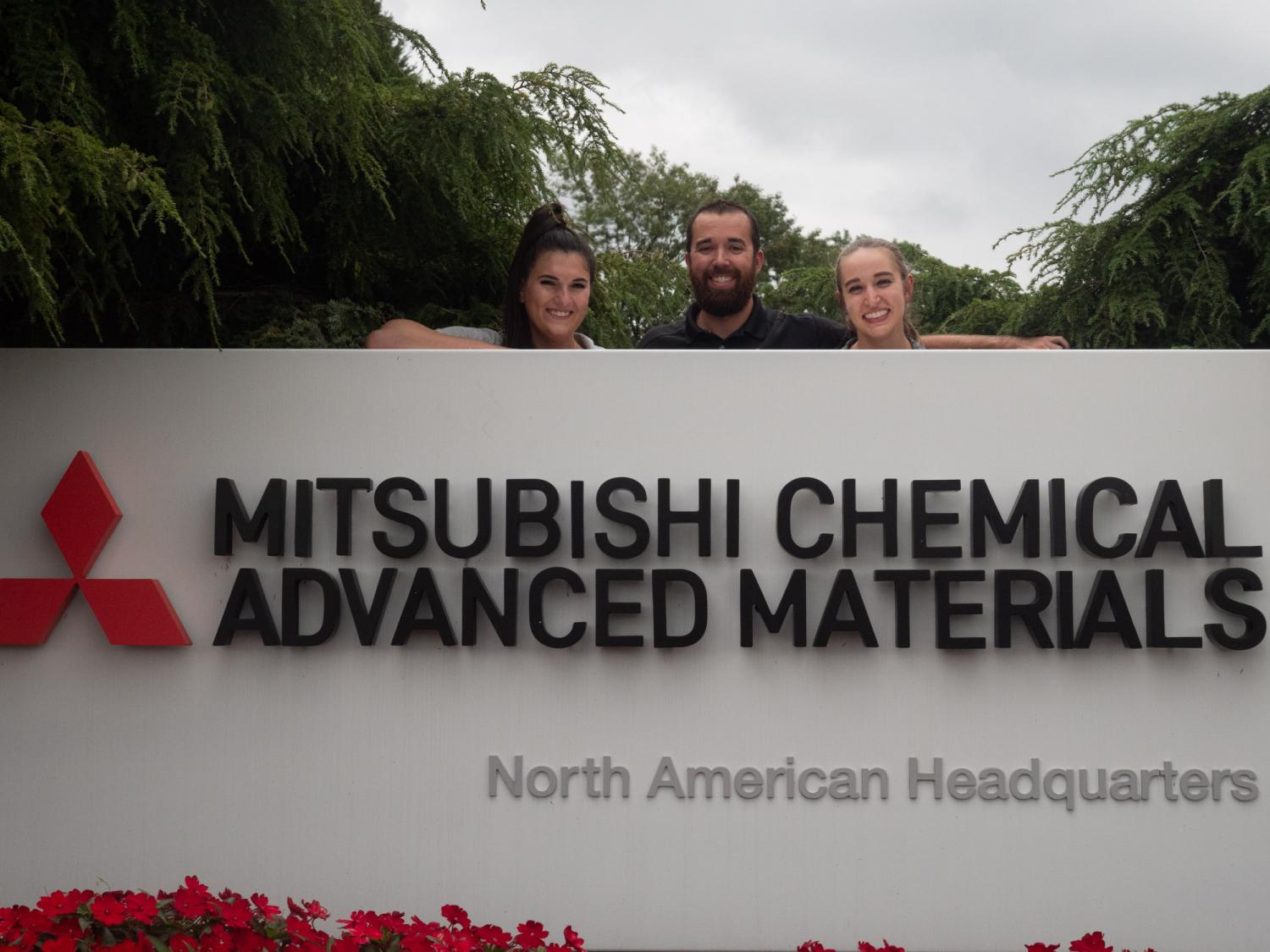 A concrete sign that reads Mitsubishi Chemical Advanced Materials North American Headquarters