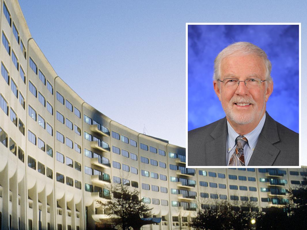 A head and shoulders professional portrait of Bruce Stanley against a background image of Penn State College of Medicine.