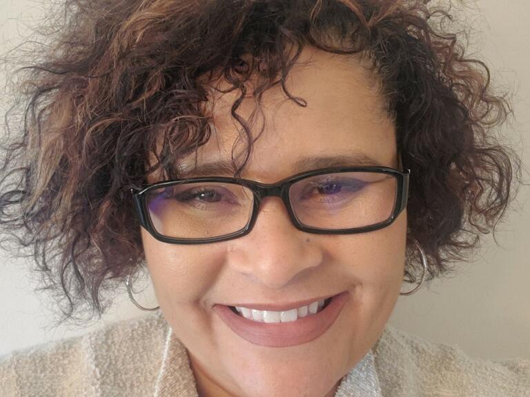 Woman smiles for headshot photo.