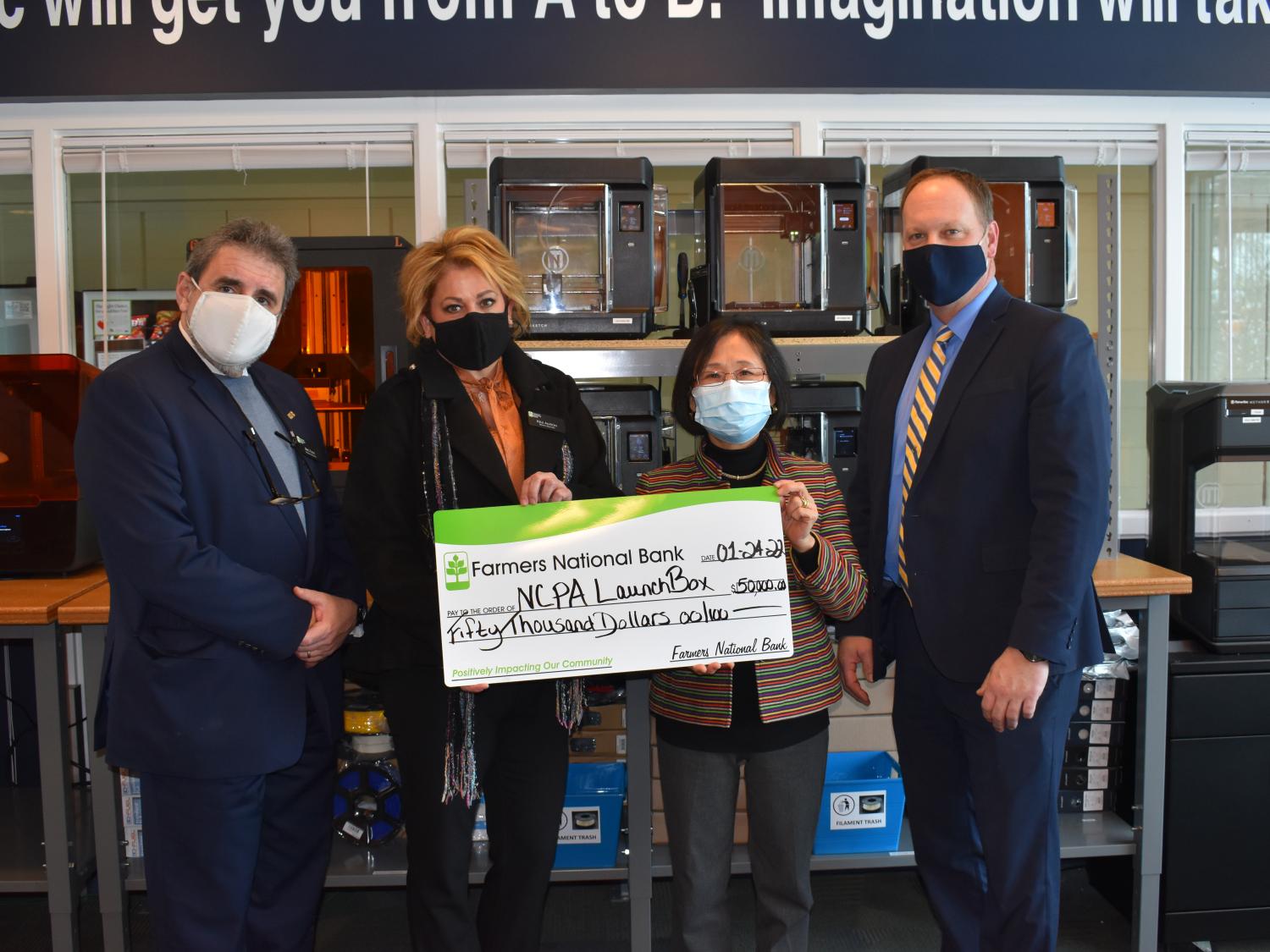 Farmer National Bank presents a $50,000 gift to NCPA LaunchBox. 