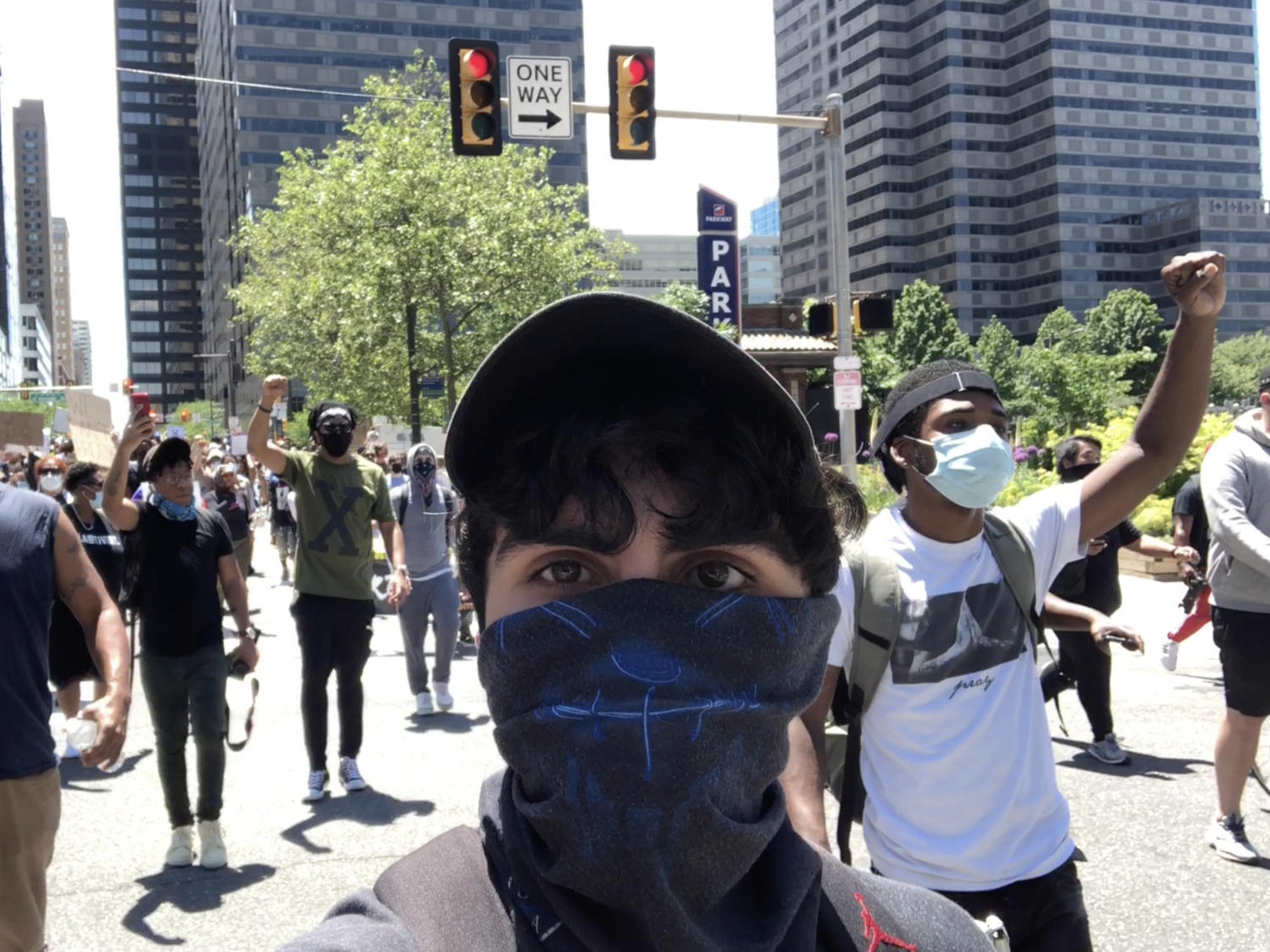 Documentarian Jacob Mejias films ahead of protestors on a Philadelphia street. 
