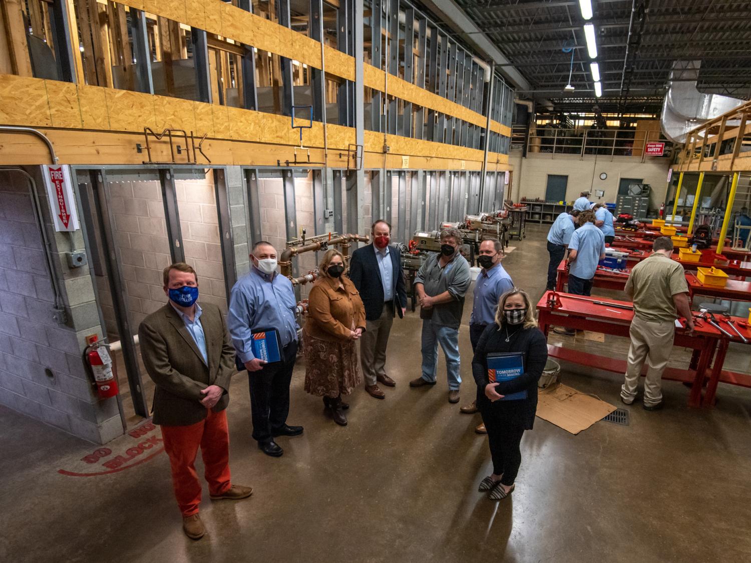 Representatives of the Air Conditioning Contractors of America and Penn College stand in the college's HVAC lab.
