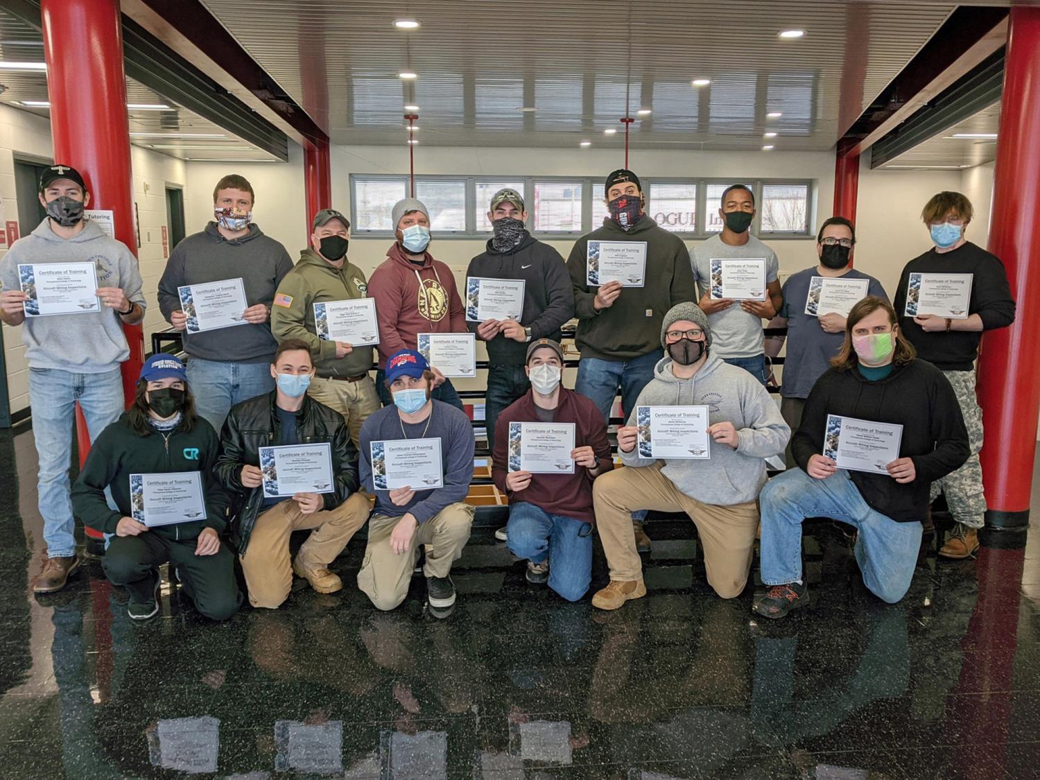 A group of people holding up their completion certificates