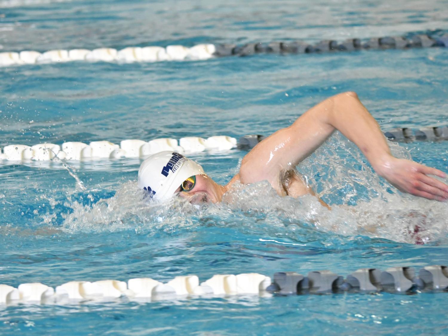 A Penn State Behrend swimmer competes in a freestyle event.