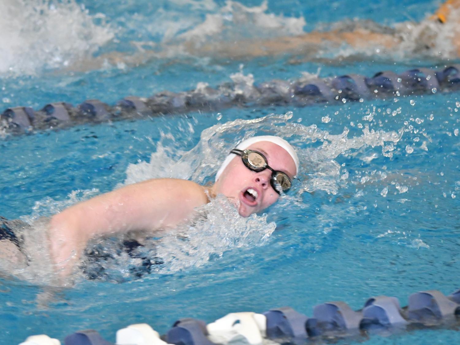 A Penn State Behrend swimmer competes in a freestyle event.