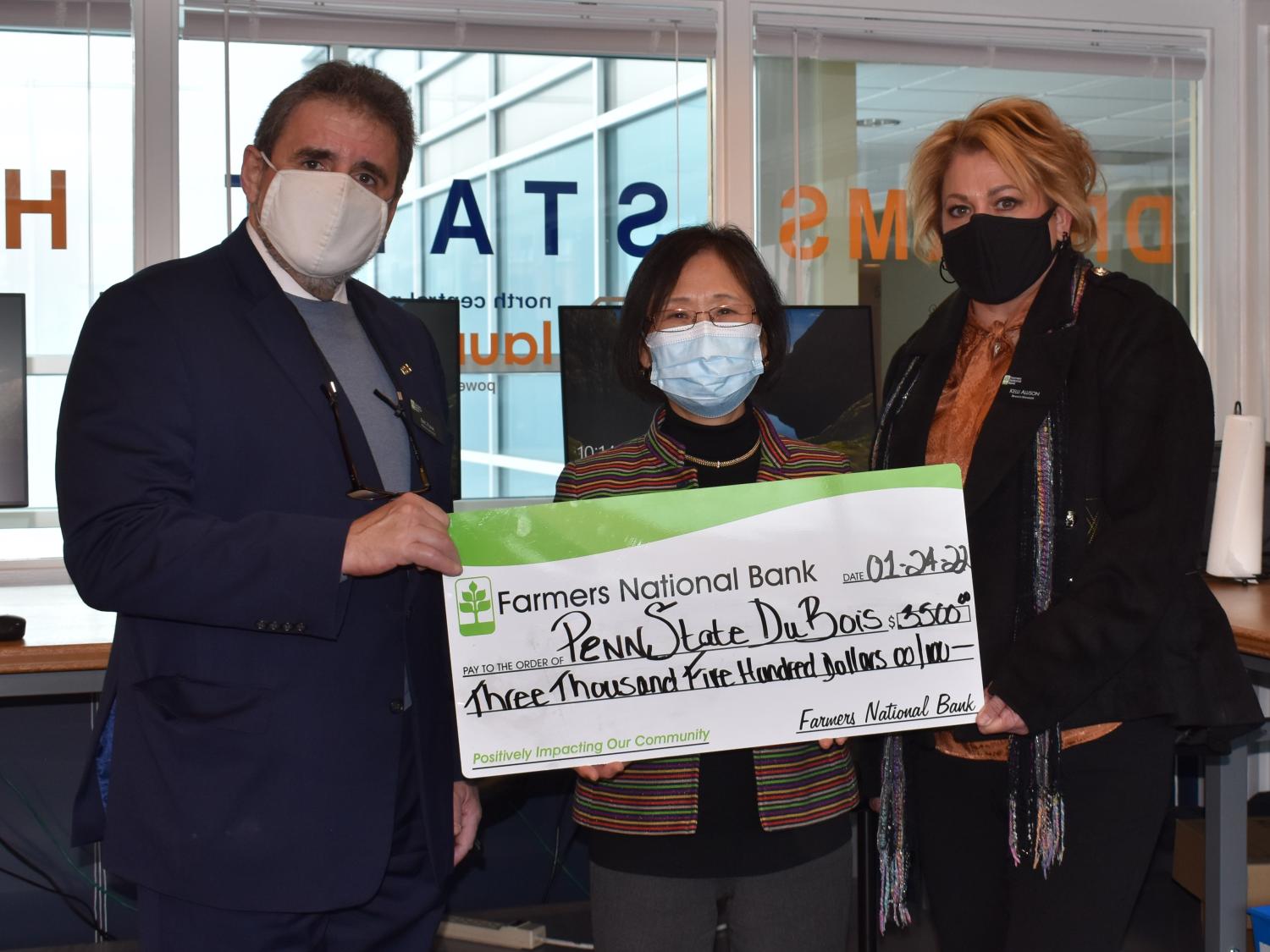 Farmers National Bank presents a $3,500 check to support offerings of youth programs on campus. 