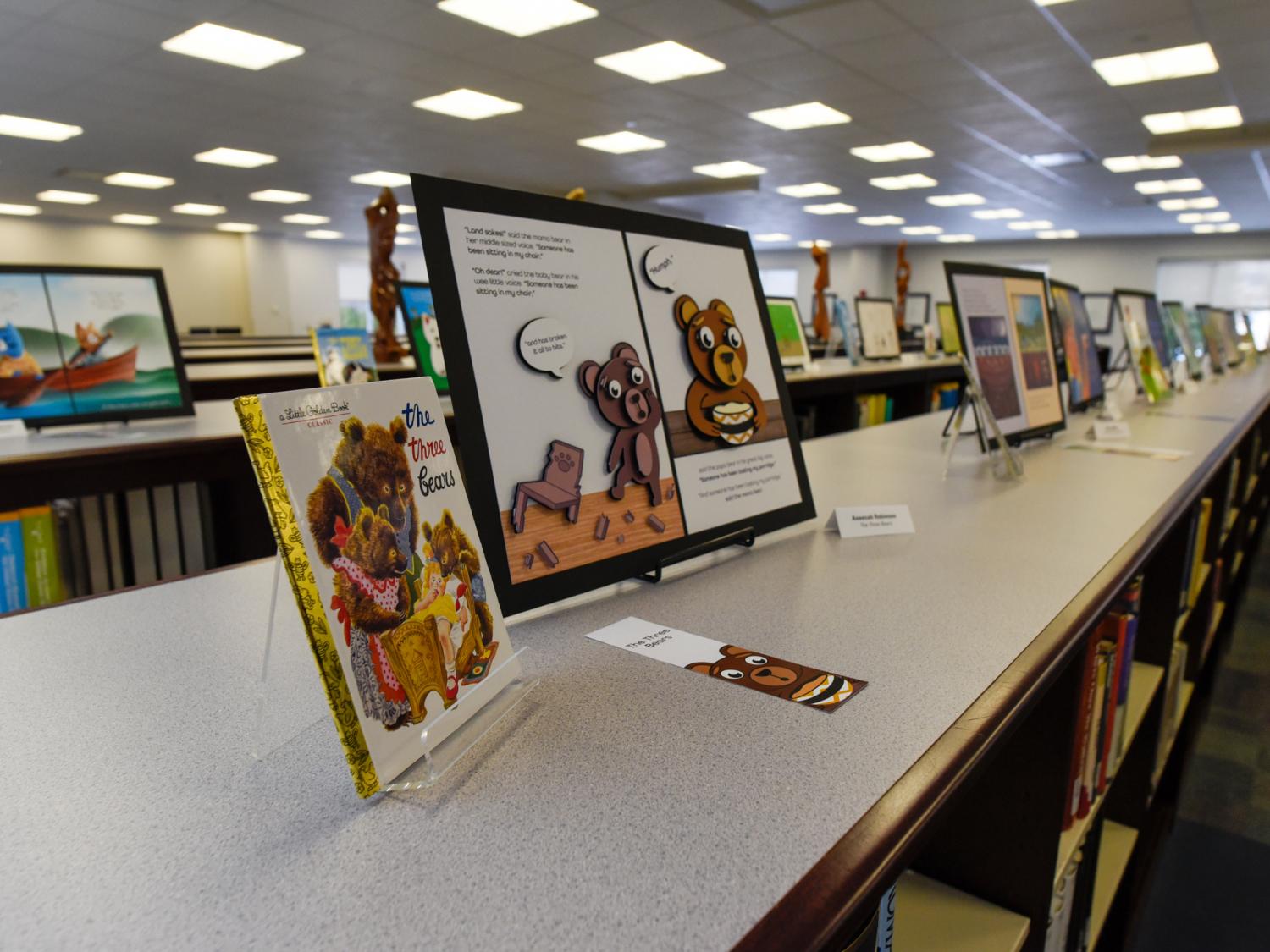 A display at the Madigan Library at Penn College, showing art displayed on library tables.