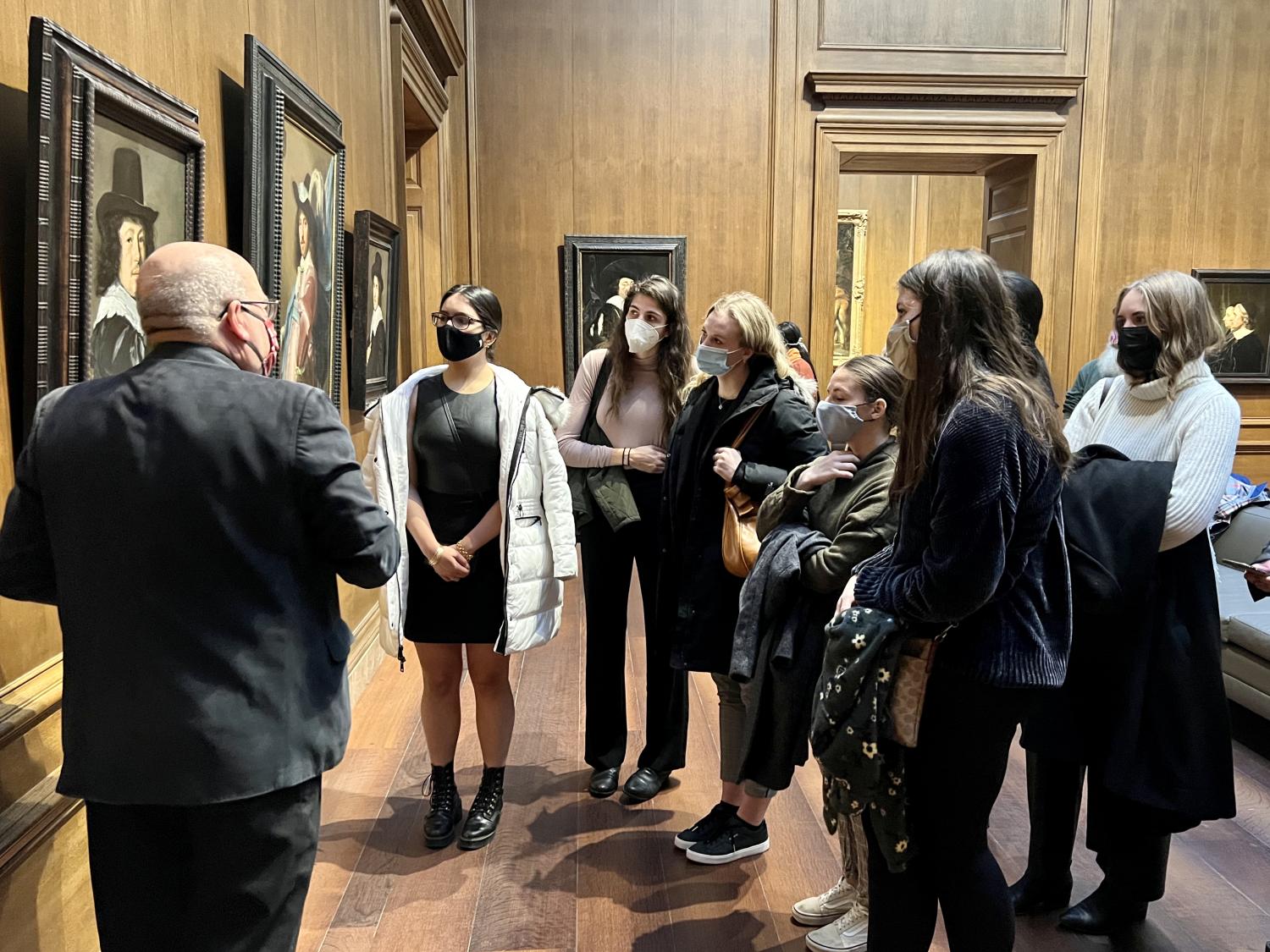 Students looking at a painting on the wall in the National Gallery of Art