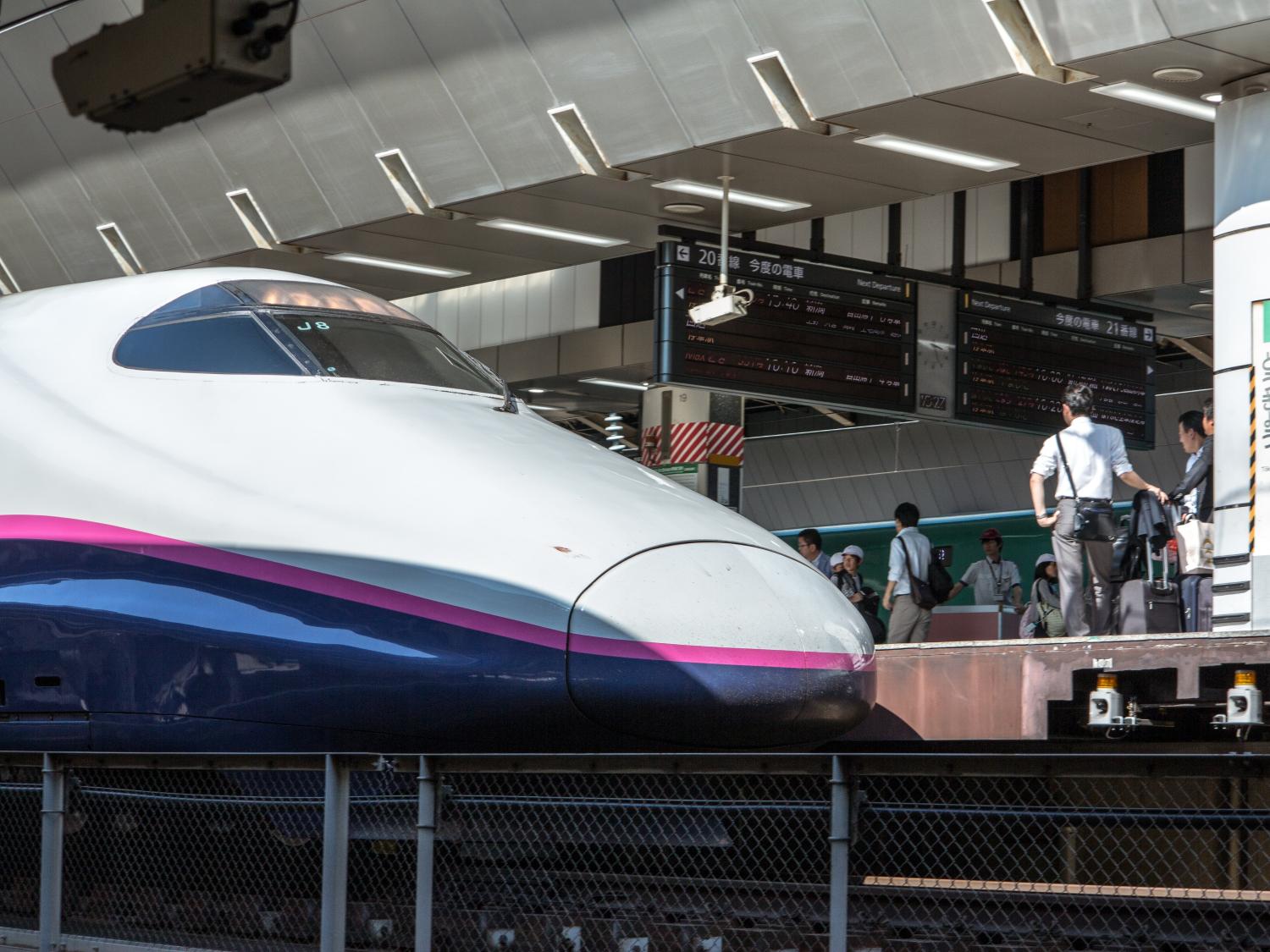 Bullet train in Japan pulled up to a station platform