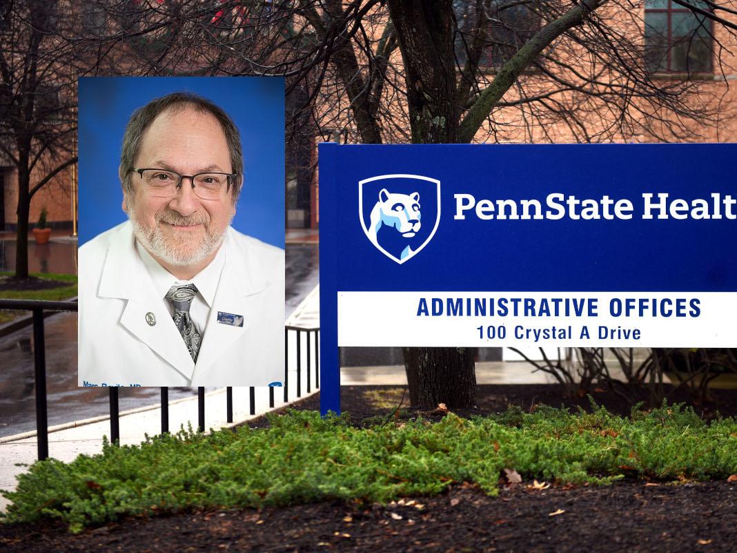A headshot of a man in a white doctor's coat
