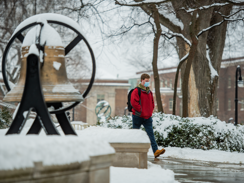 Student walking on campus in winter.