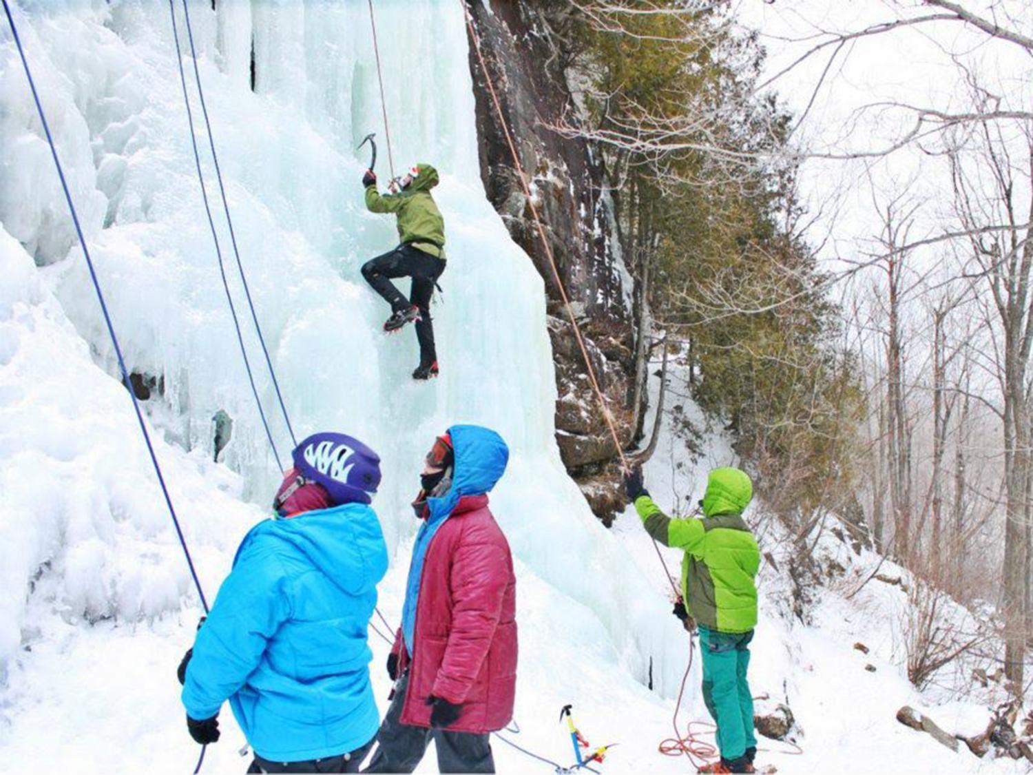 Students climbing up a mountain of ice