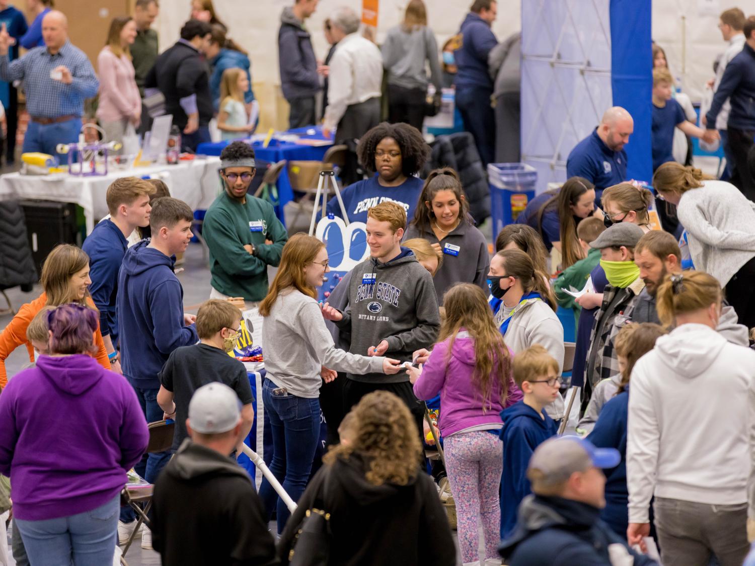 People look at exhibits at the Penn State Behrend STEAM Fair.