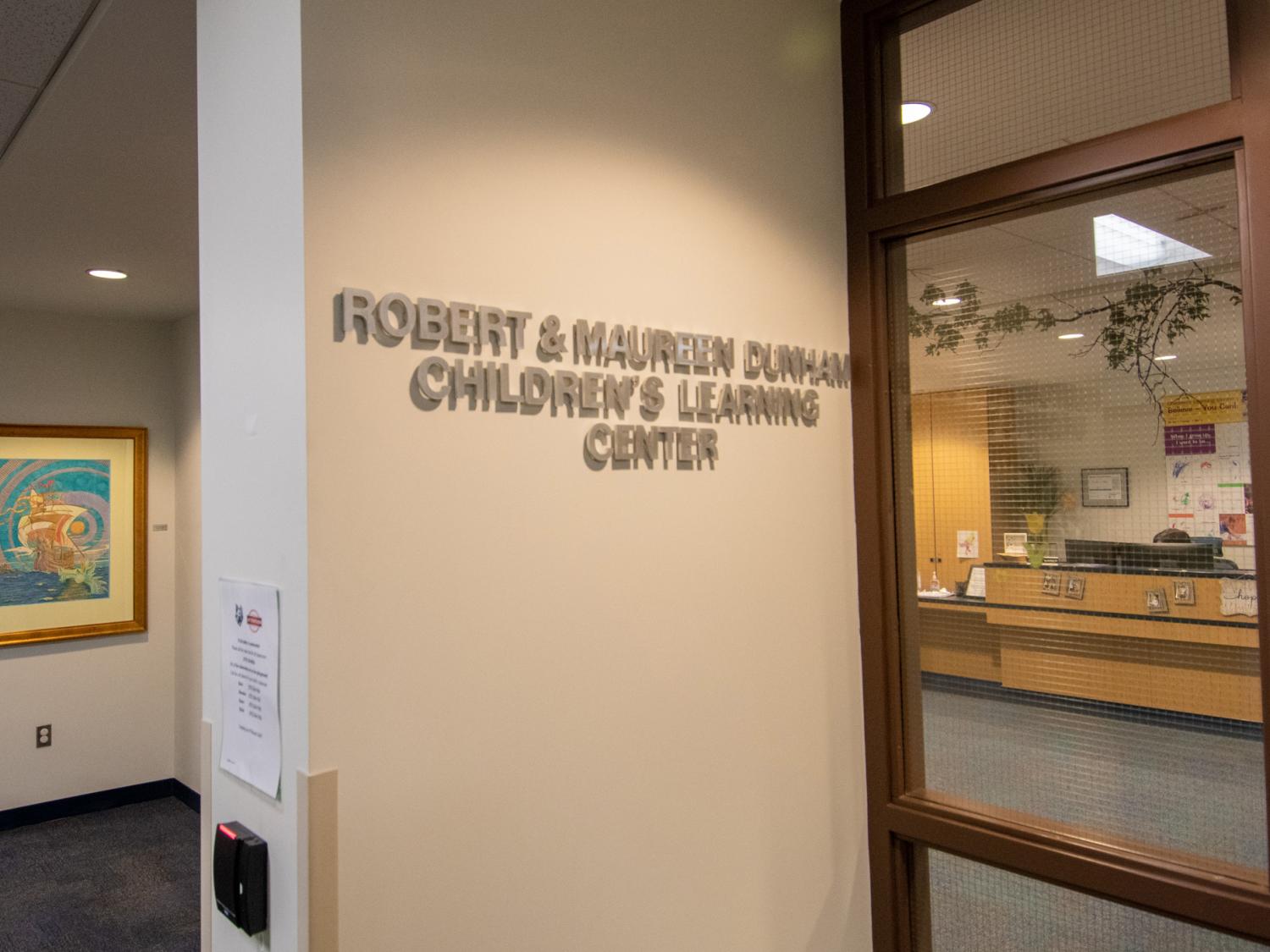 A sign on a wall that reads The Robert and Maureen Dunham Children’s Learning Center