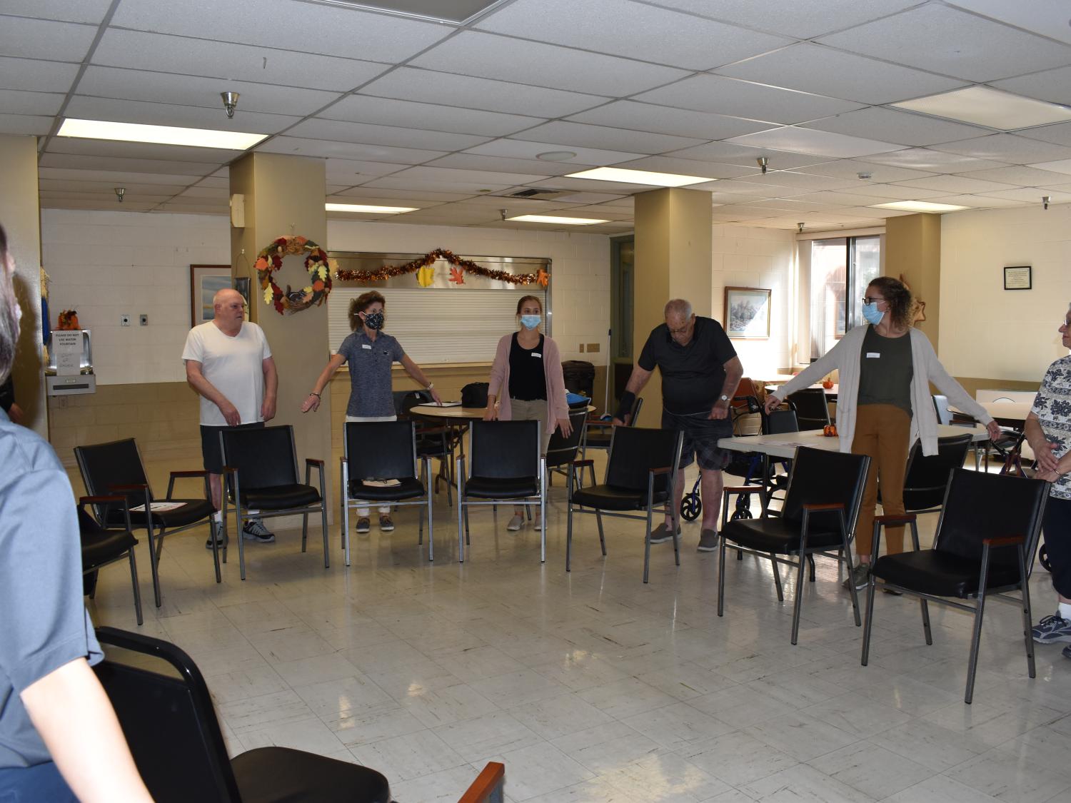 OTA students lead senior in an excercise. 