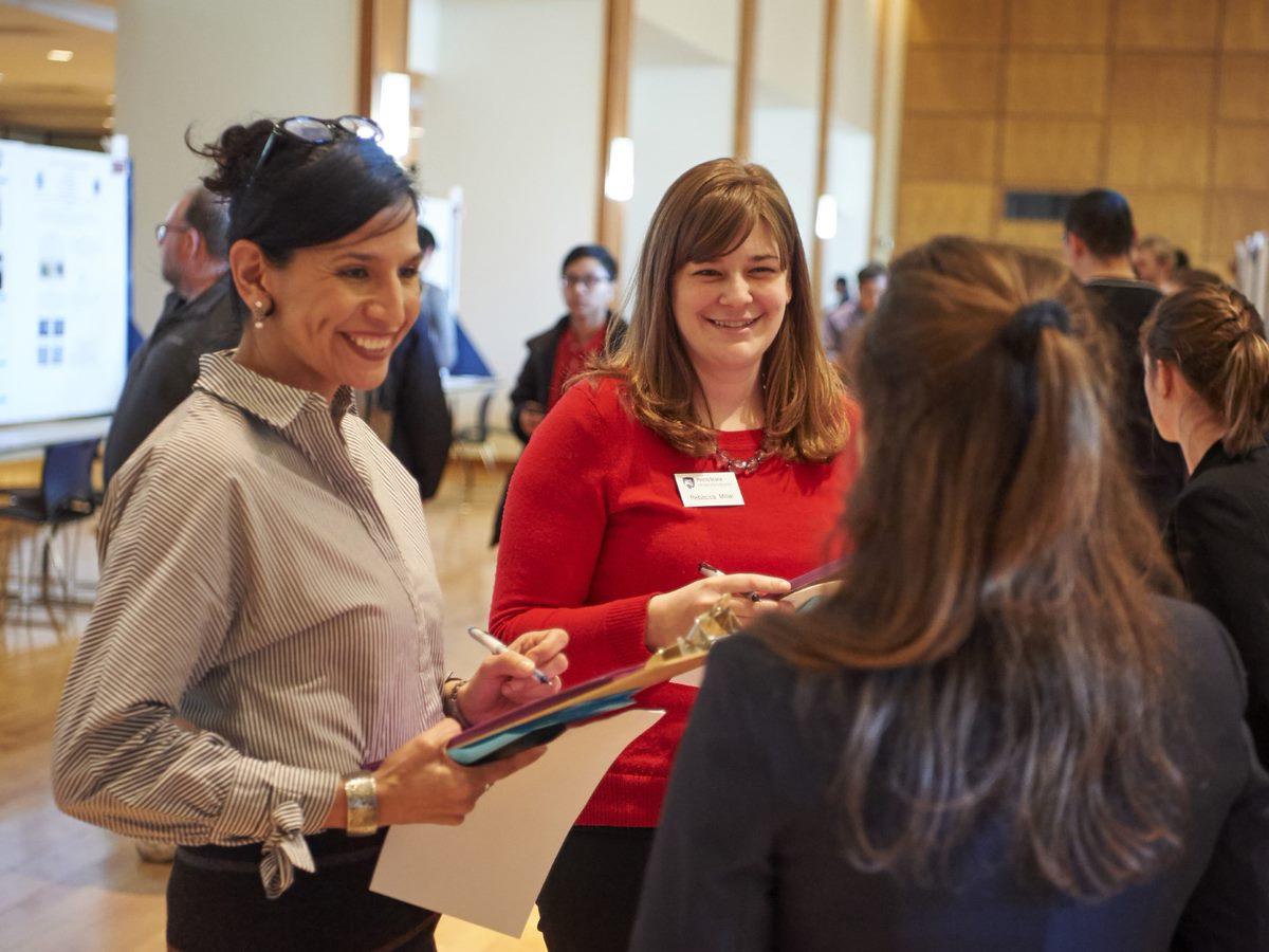 Judges and students talk during Undergraduate Exhibition