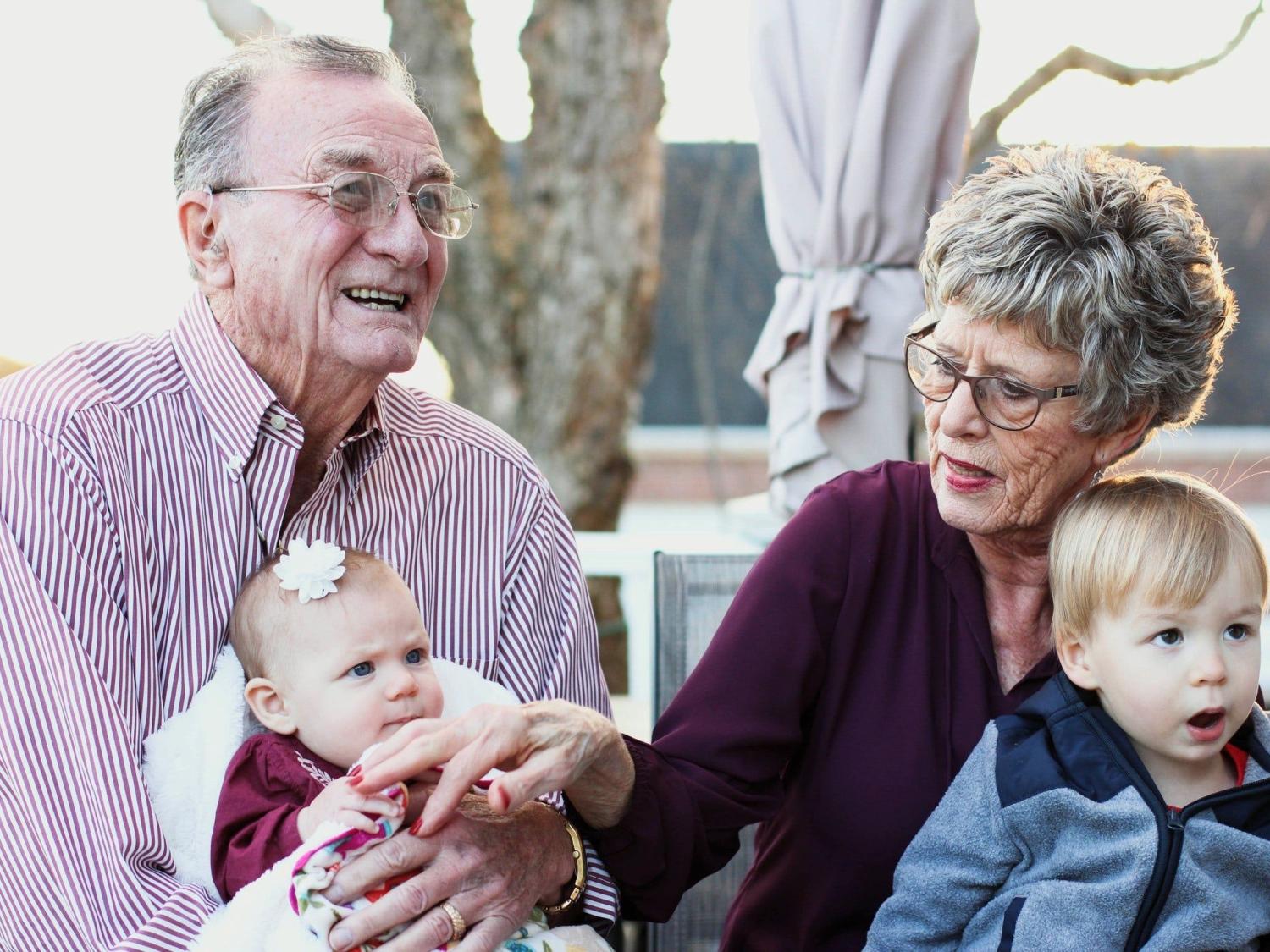Grandparents with grandchildren on their laps
