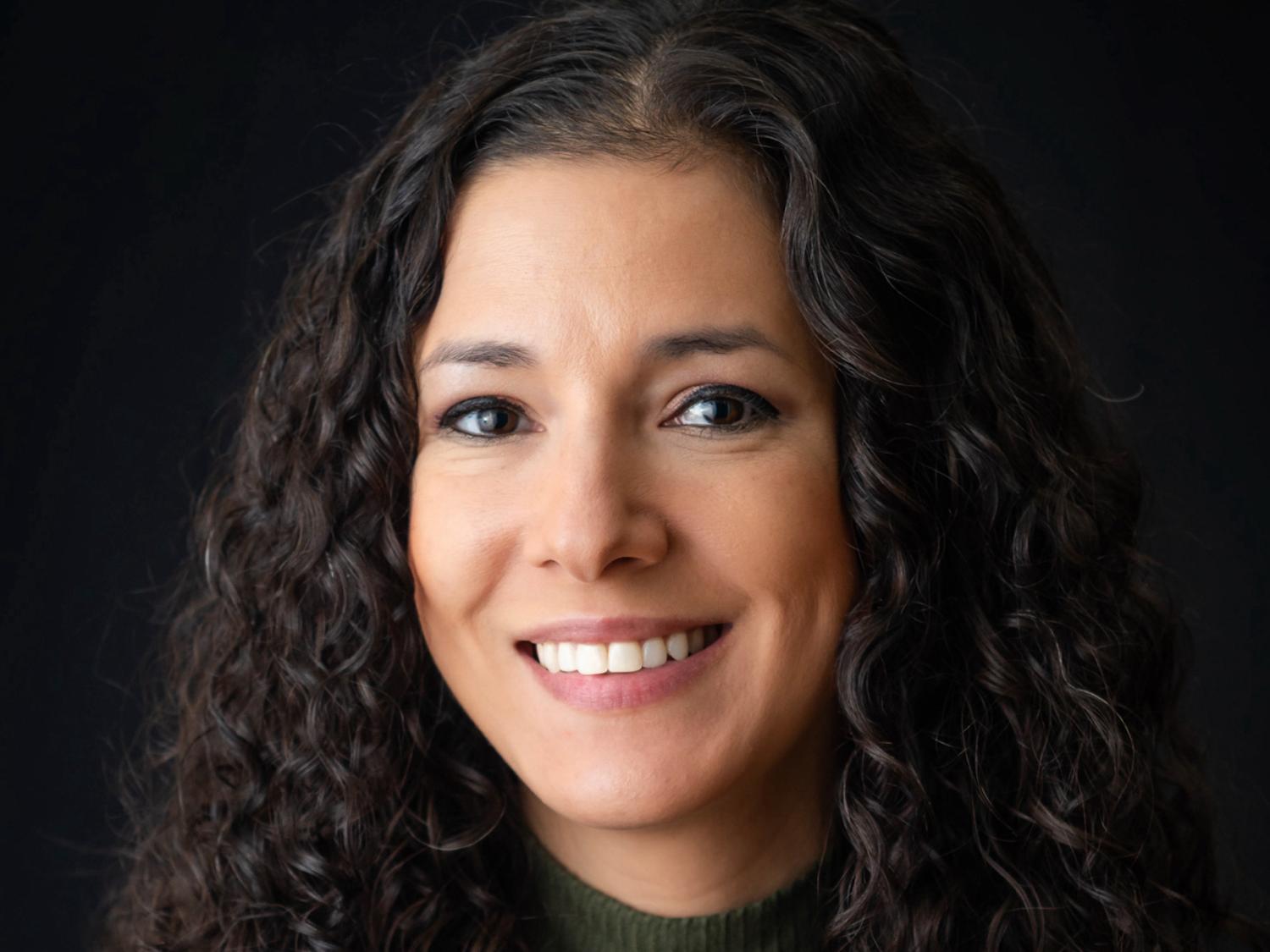 Headshot photo of Jennifer Wahl against a black background