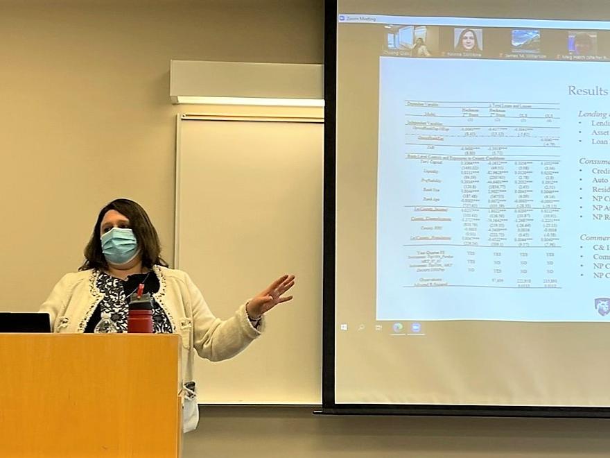 Professor Nonna Sorokina presenting her research findings to students in classroom and via zoom