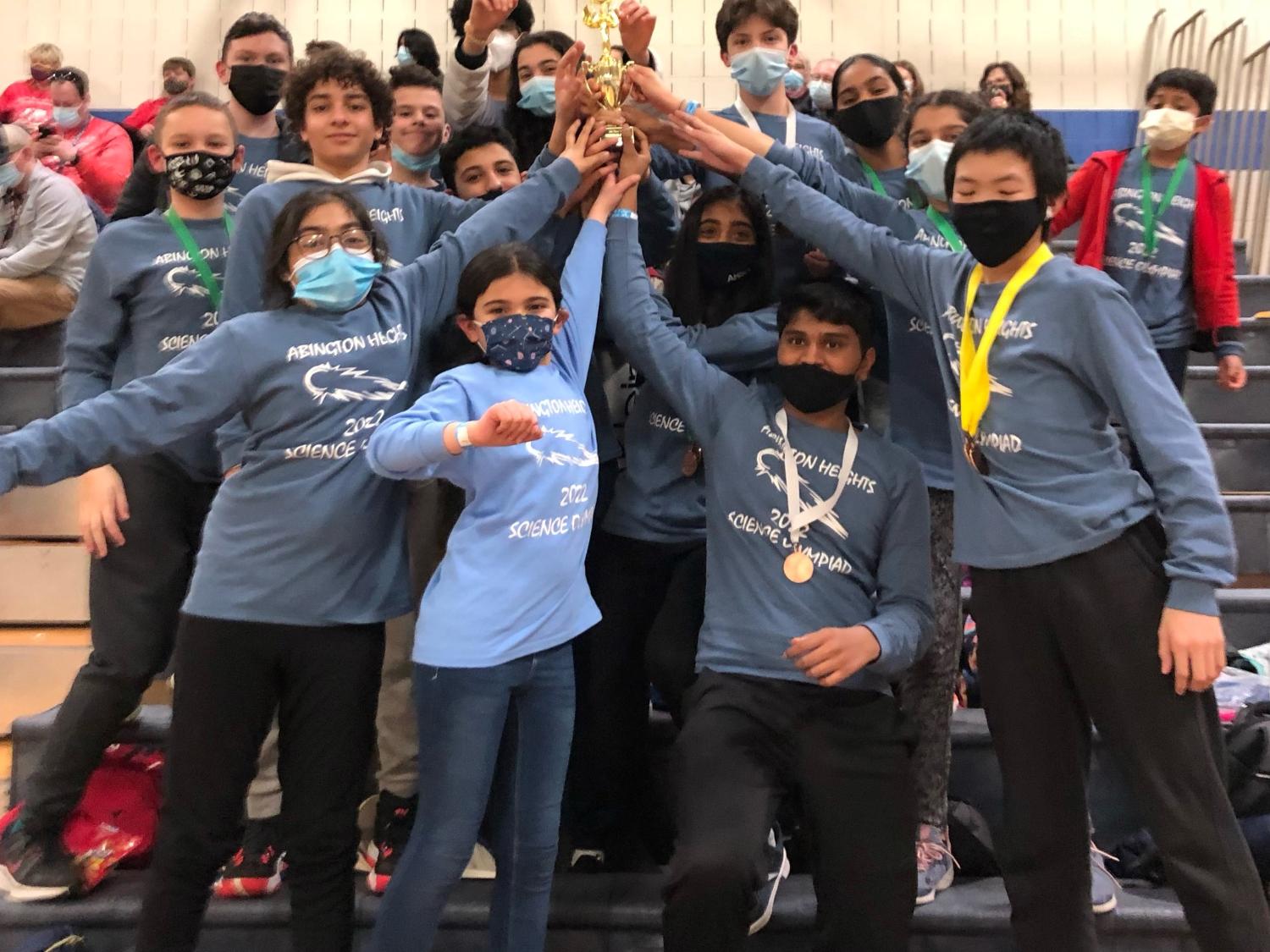 Abington Heights Science Olympiad team hoisting trophy