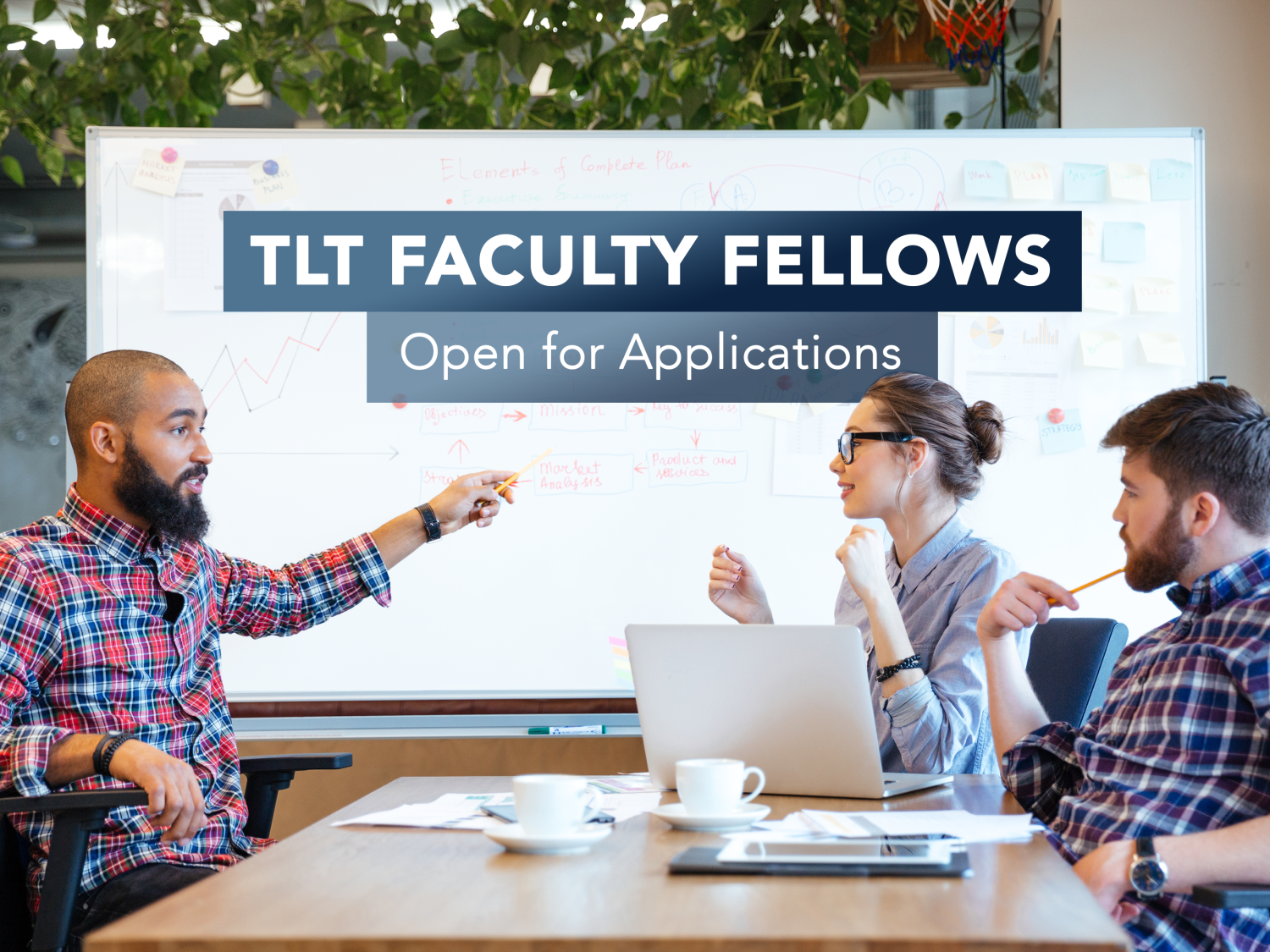 Image of three people in a classroom with a white board.