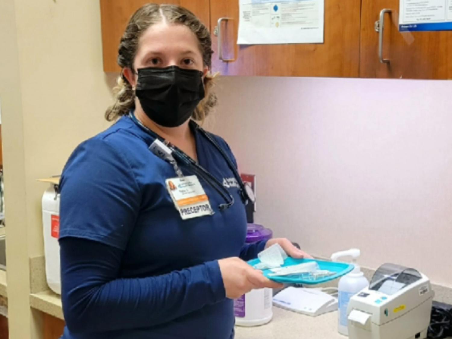 Taylor Argeson stands in exam room 