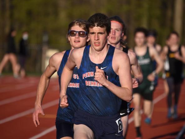 Two Penn State Behrend runners lead the pack in an outdoor track race.