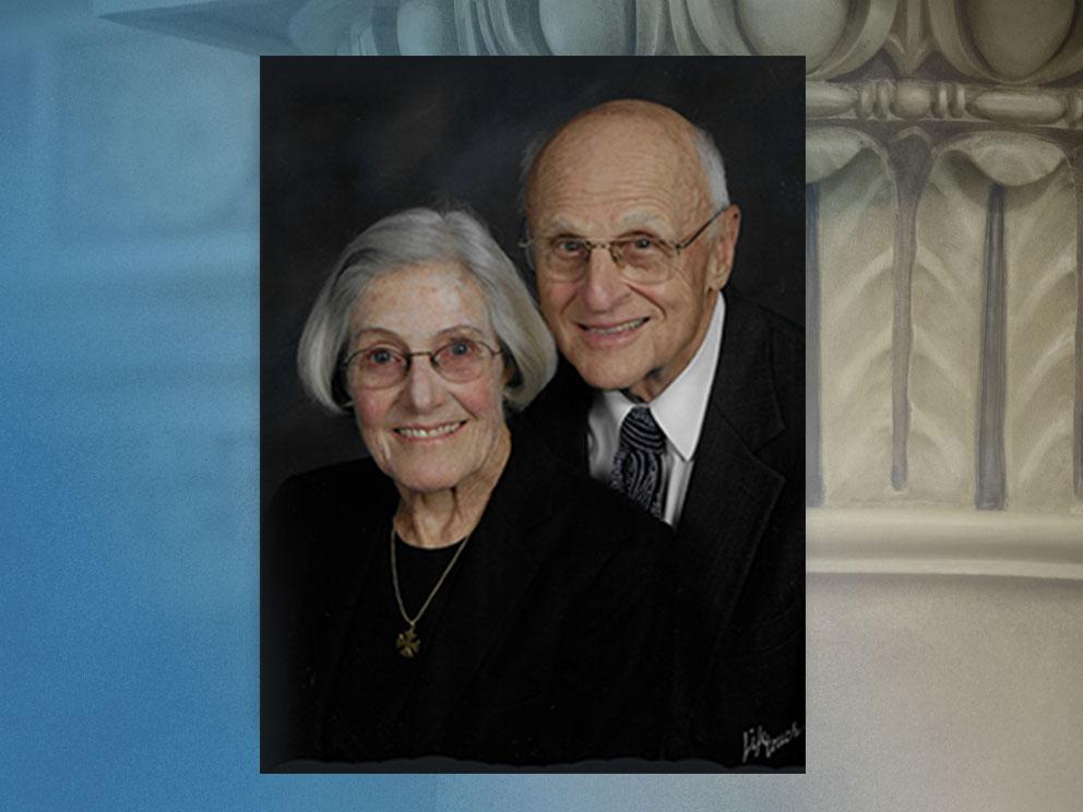 A portrait of a man and a woman smiling at the camera