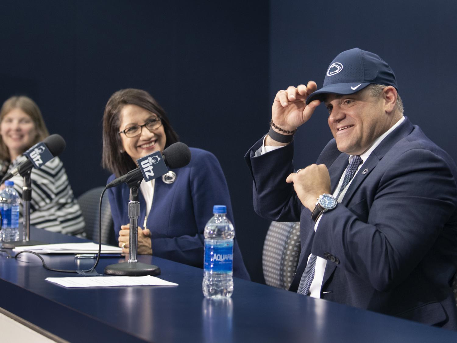 Patrick Kraft tries on Penn State hat at press conference