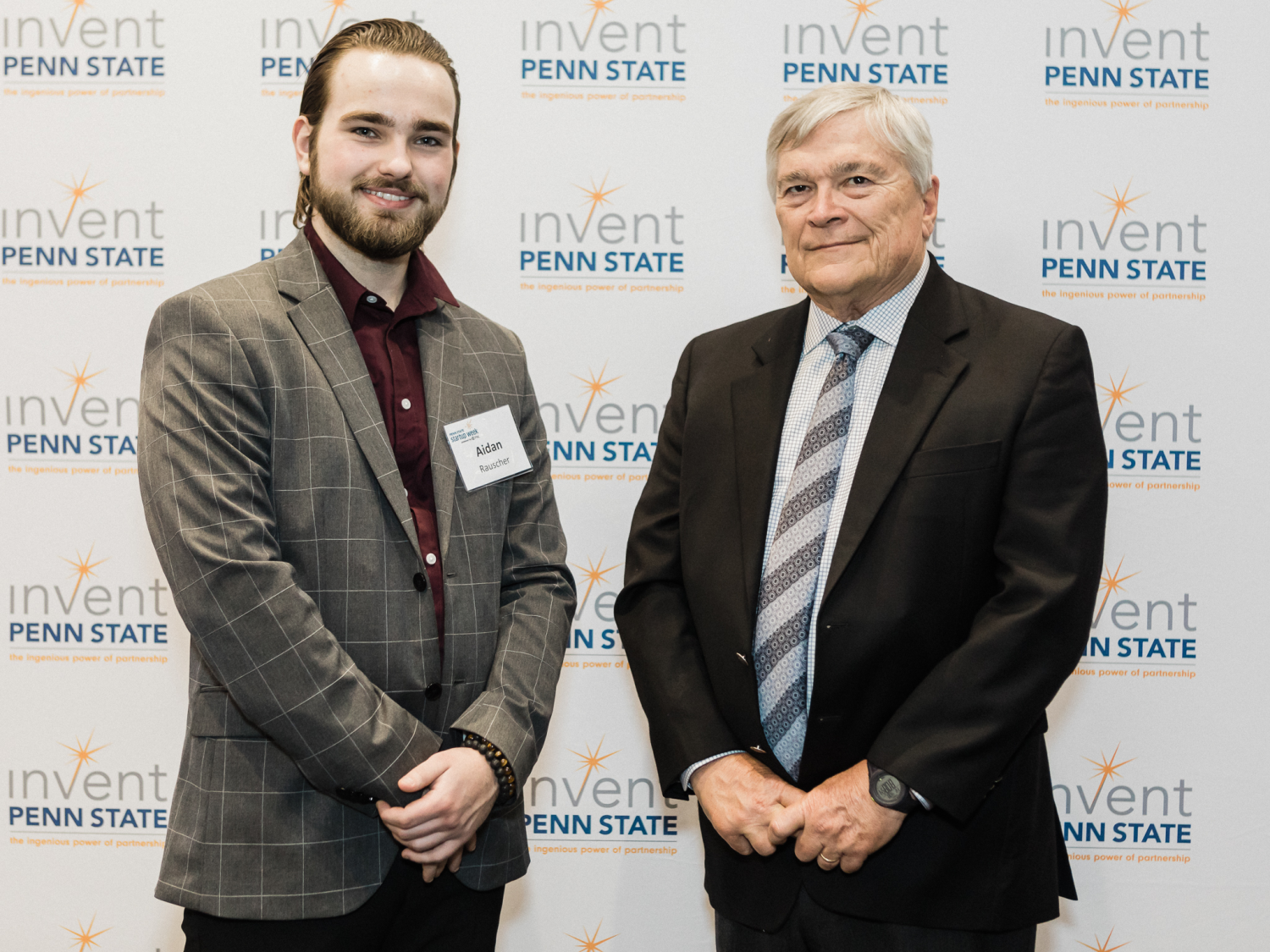 Table Rock Markets co-founder stands next to Penn State President Barron
