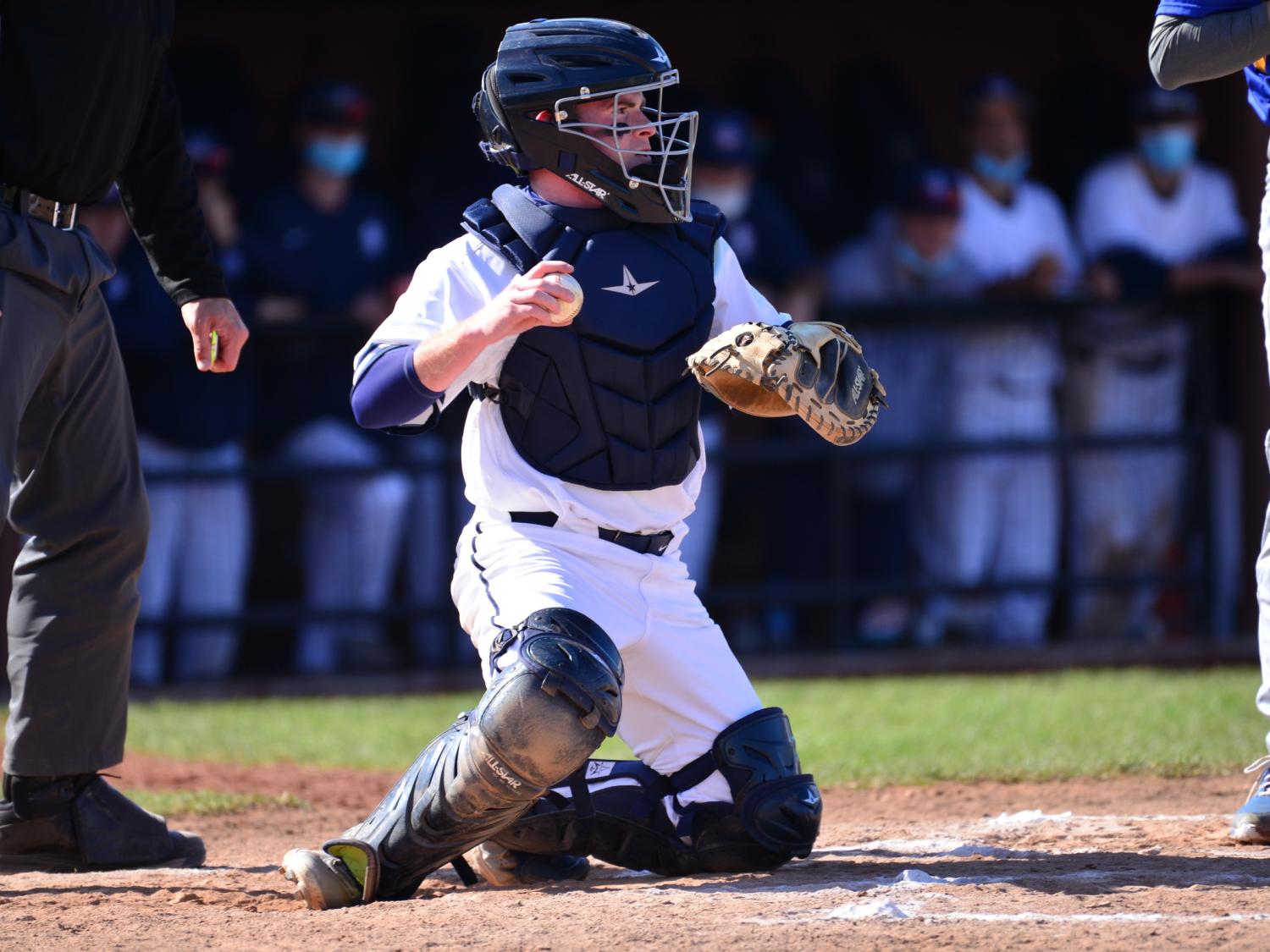 A catcher for the Penn State Behrend baseball team throws the ball.