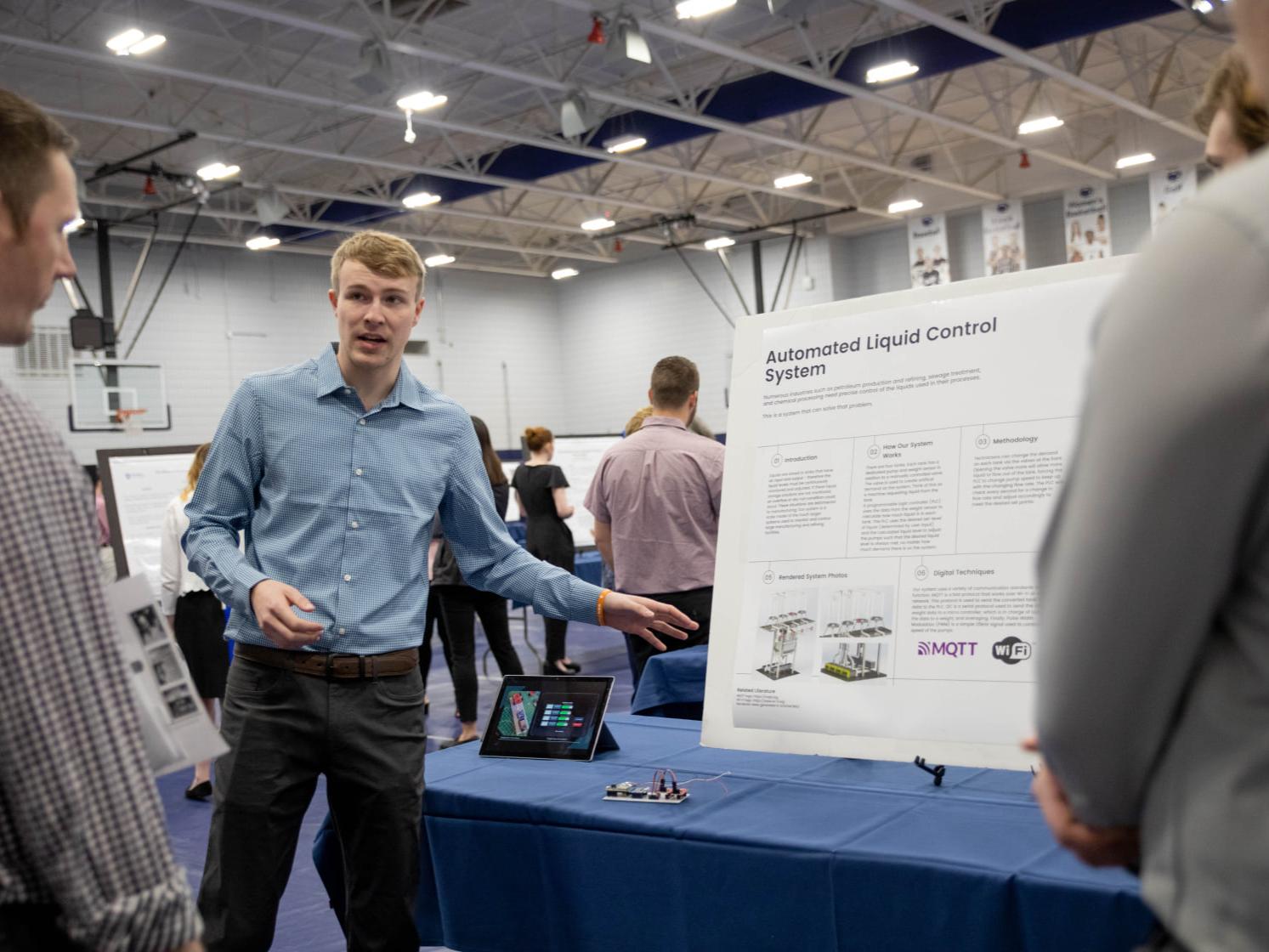 Student presents research project at table