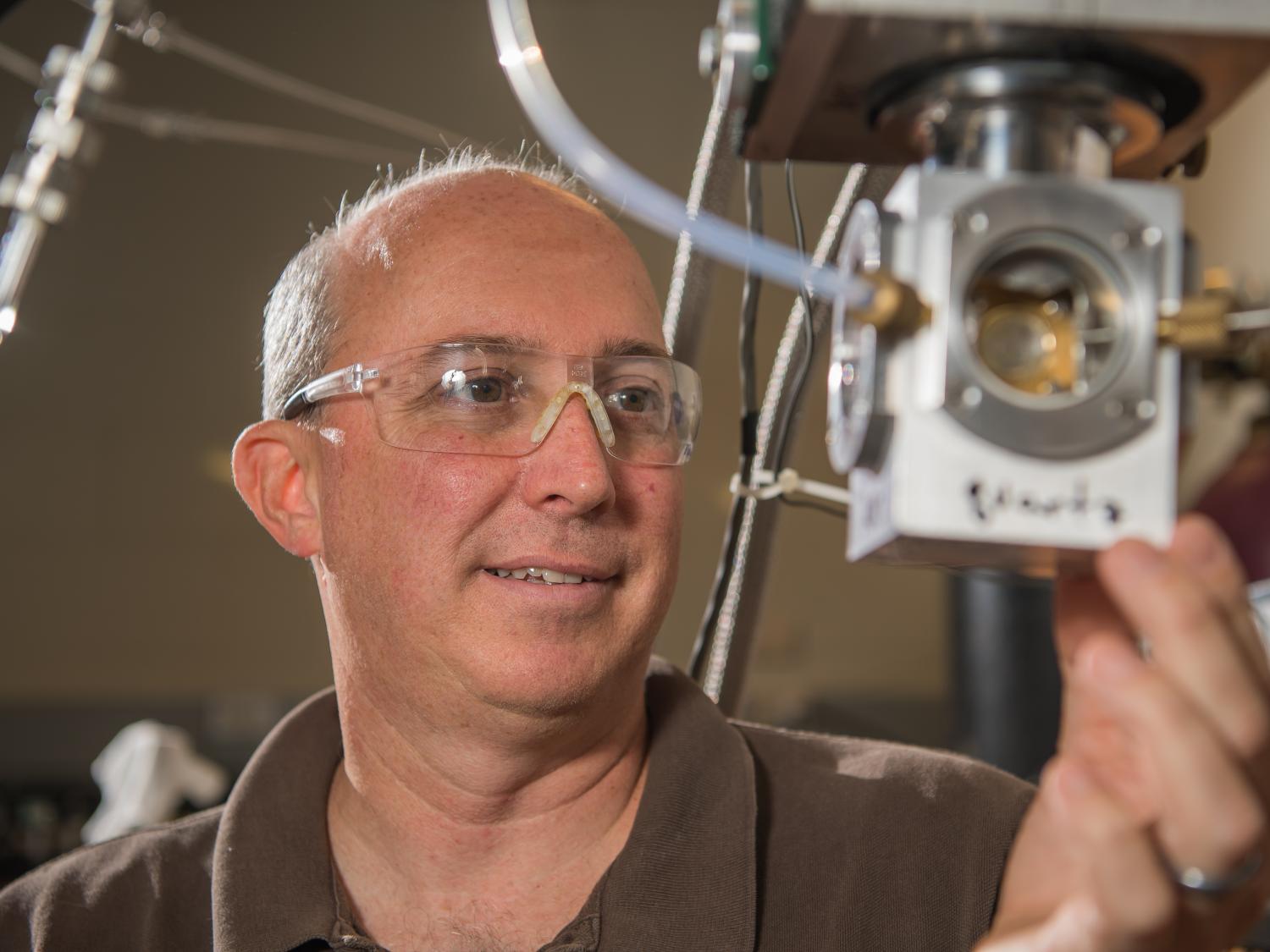 Jay Amicangelo, professor of chemistry at Penn State Behrend, works in the lab.