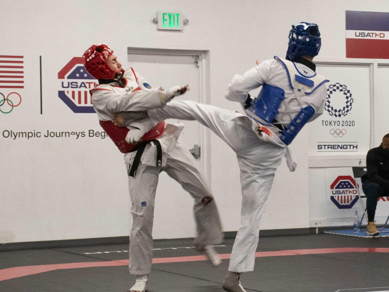Joshua Liu spars with another person in a gym.
