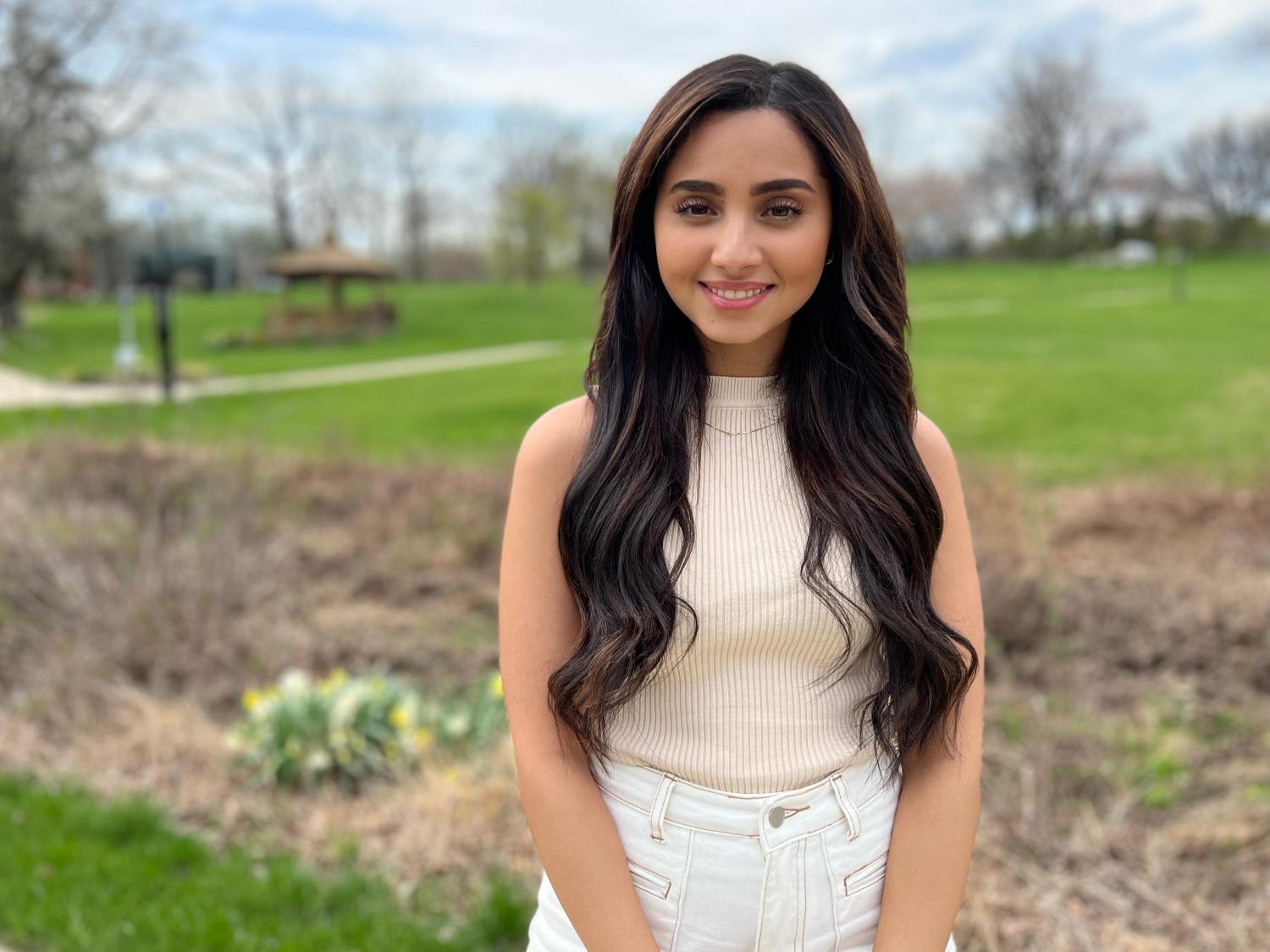 A female student standing on the campus lawn.